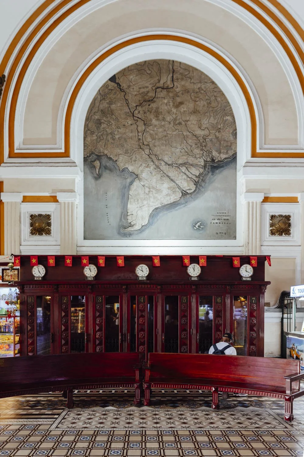 wooden stalls and arched interior wall with map at saigon central post office