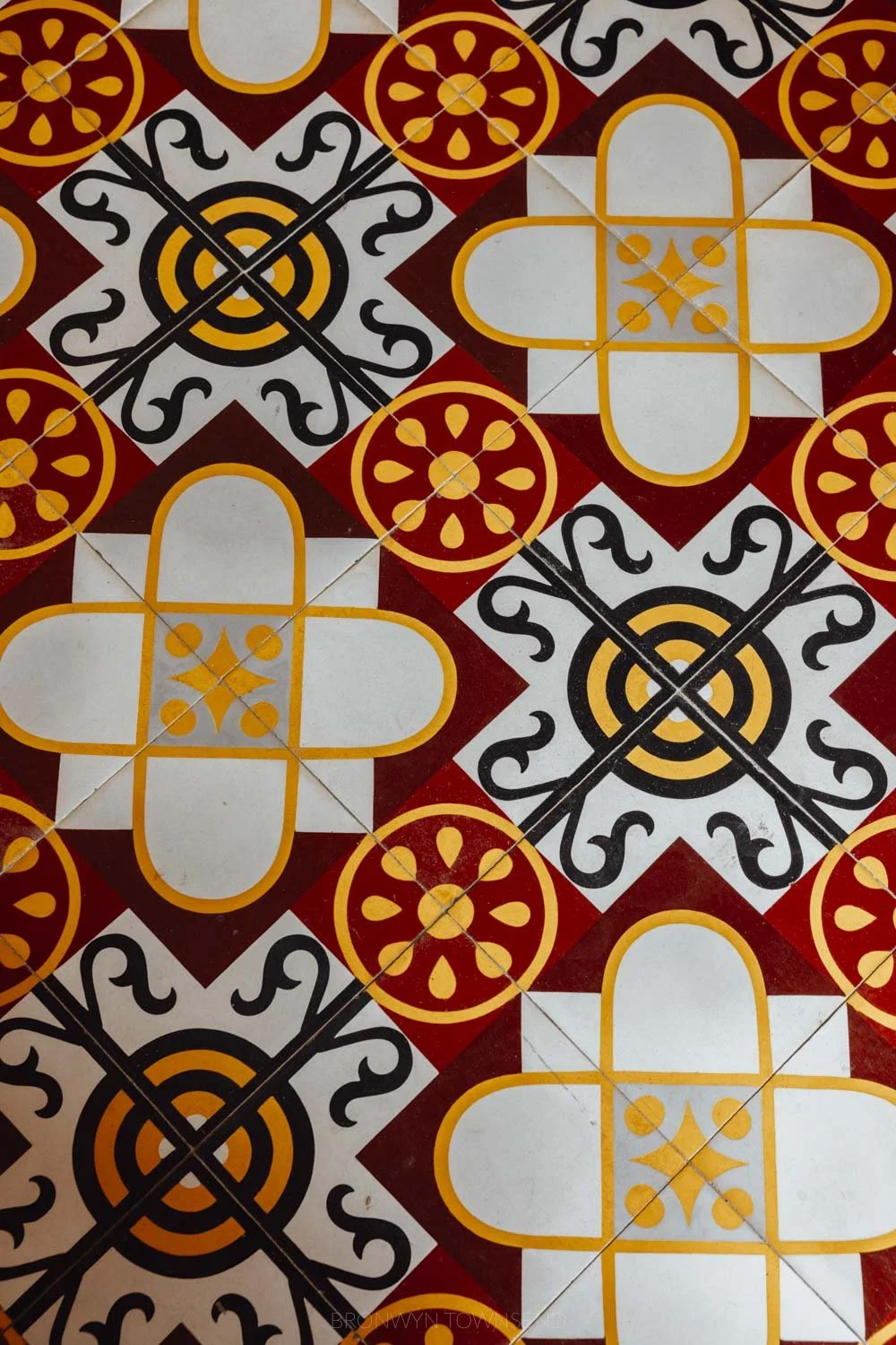 Red, yellow, and white patterned retro floor tiles
