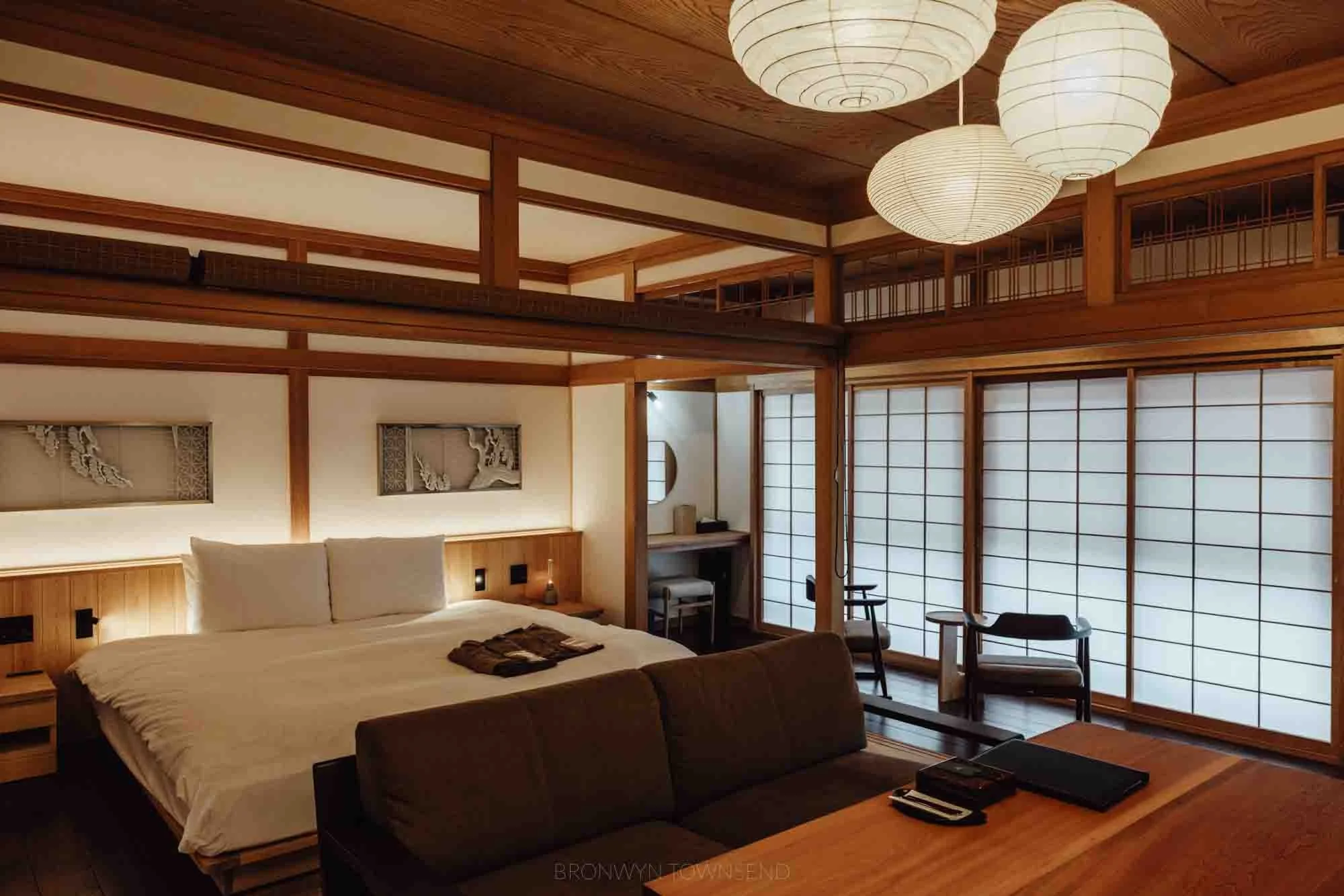 Luxury guest room at BYAKU Narai in Narai-juku, Japan, featuring a minimalist Japanese design with shoji screens, wooden interiors, and soft ambient lighting.