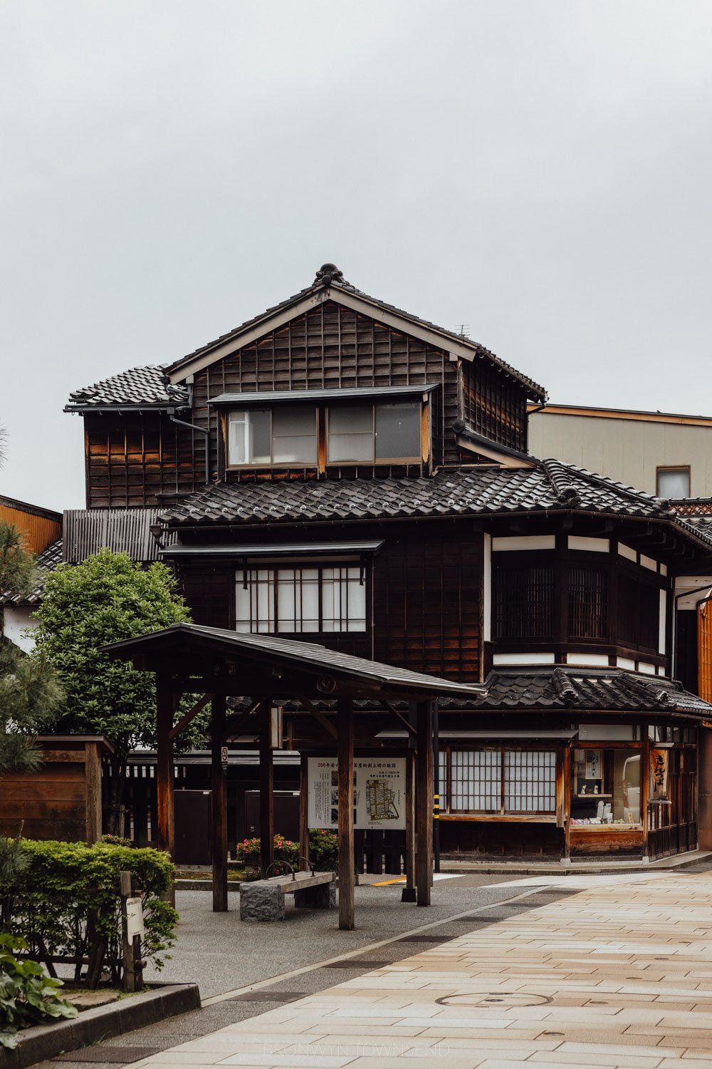 Higashi Chaya, Kanazawa. Three storey wooden latticed townhouse with small trees in the foreground