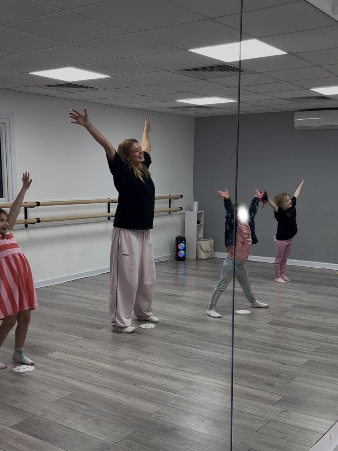 Act One Beginners SEN Drama teacher and students smiling with arms up reflected in mirror during inclusive drama class Dormansland East Grinstead