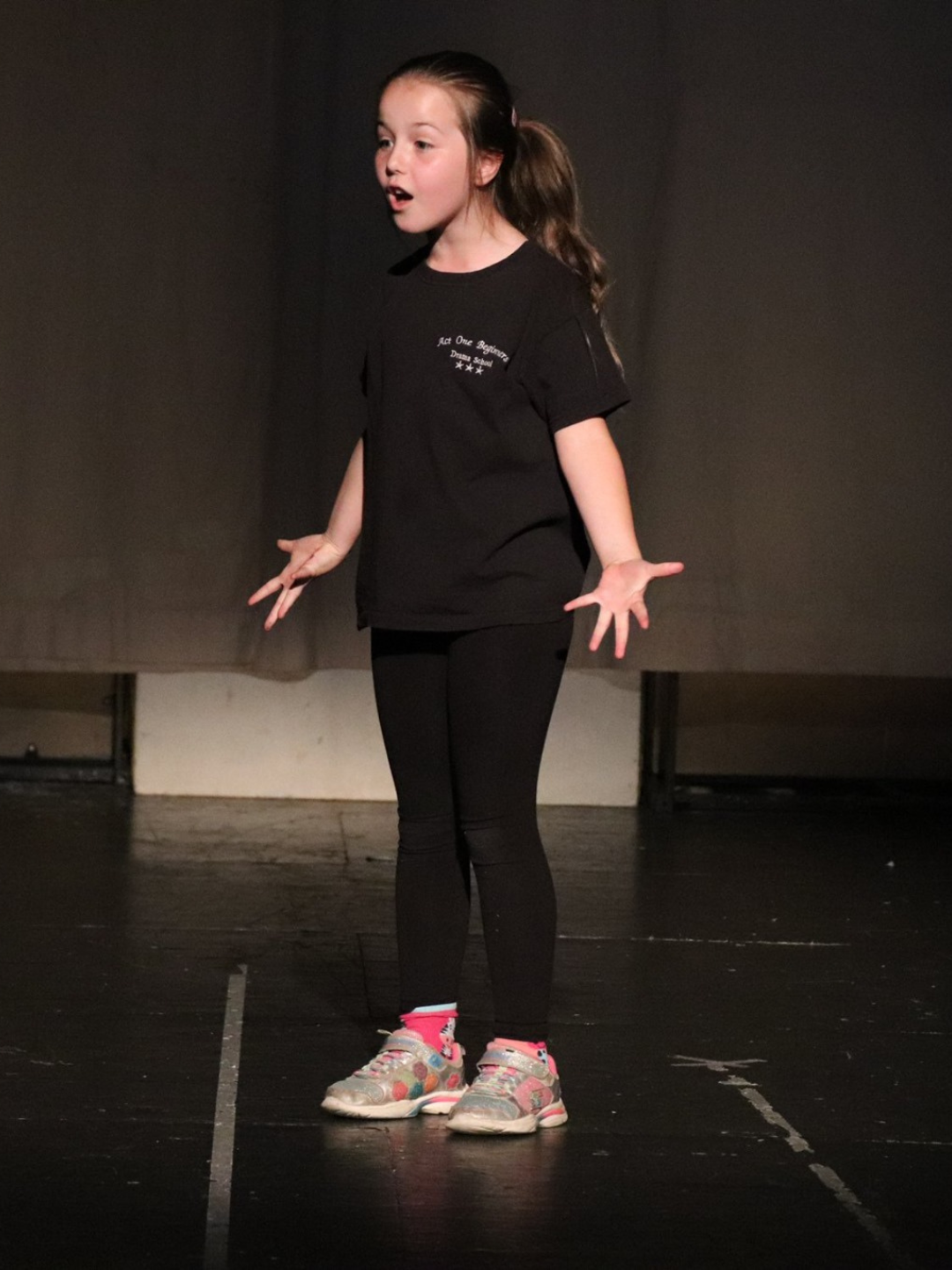 Children practising public speaking skills in a drama class