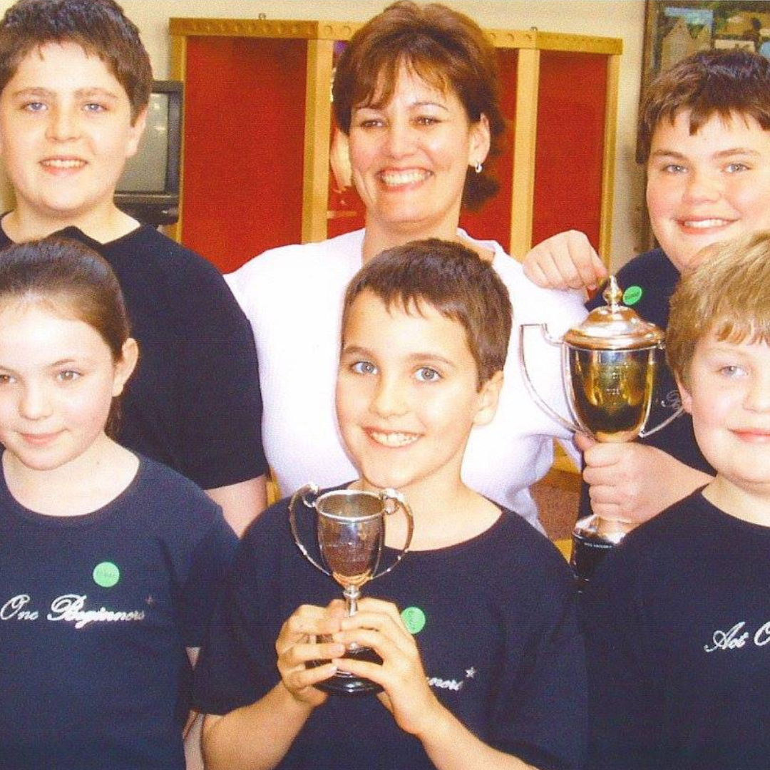Act One Beginners founder Beverly Hewitt pictured with drama students holding trophies at children's drama school East Grinstead