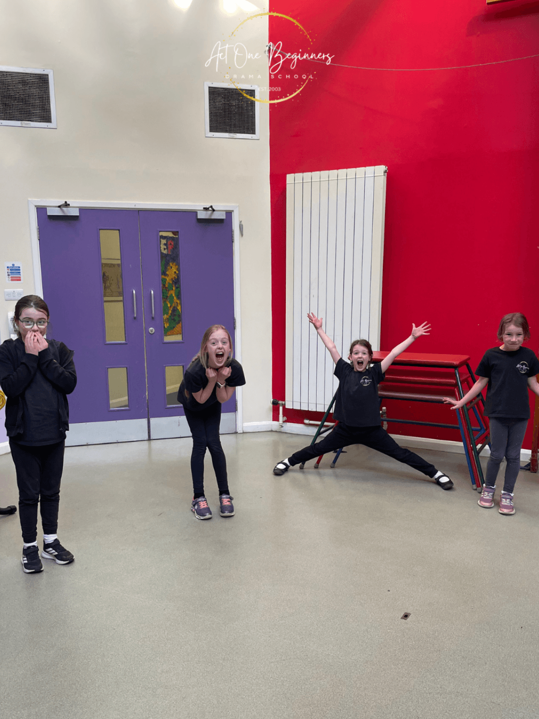 Children practising public speaking skills in a drama class