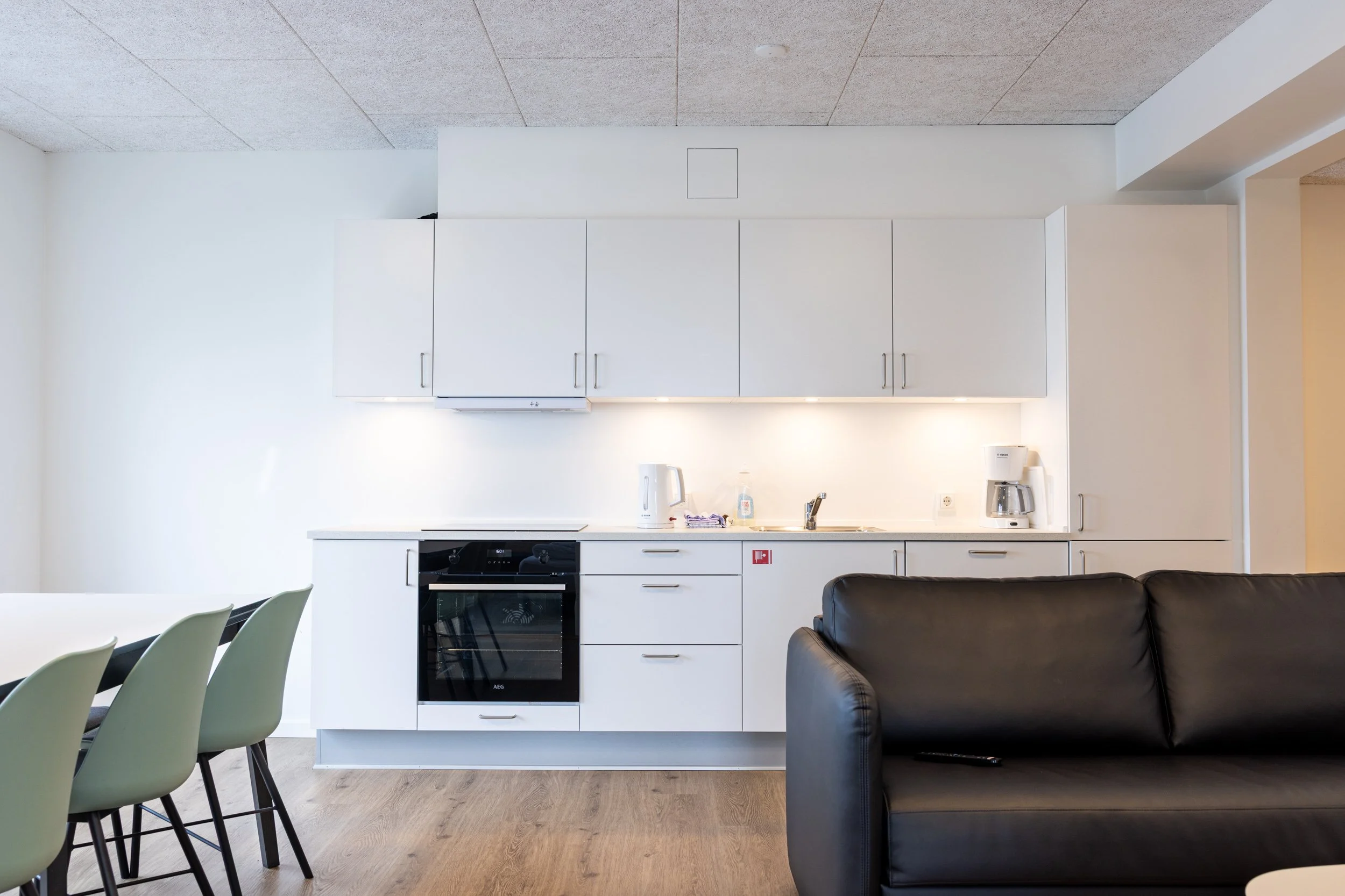 The apartment features a fully equipped kitchen with everything you need for a comfortable stay. The kitchen includes an oven, stove, refrigerator with freezer, dishwasher, coffee machine, electric kettle, toaster, cookware, tableware, glasses, and k