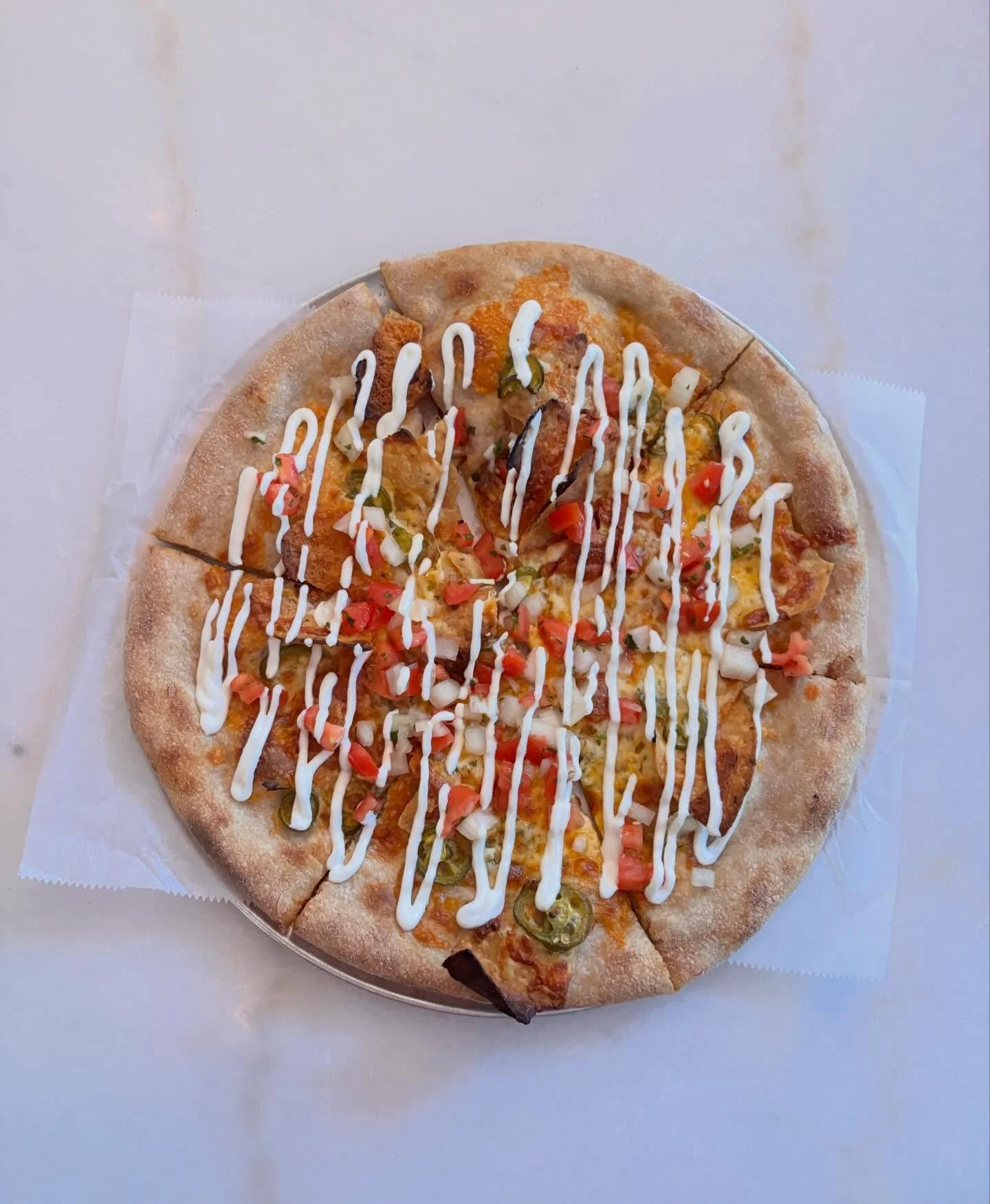 new white special! 🍕

white pizza with tortilla chips, cheddar and mozzarella cheese, pickled jalape&ntilde;os, pico de gallo and a sour cream drizzle

open till 9!