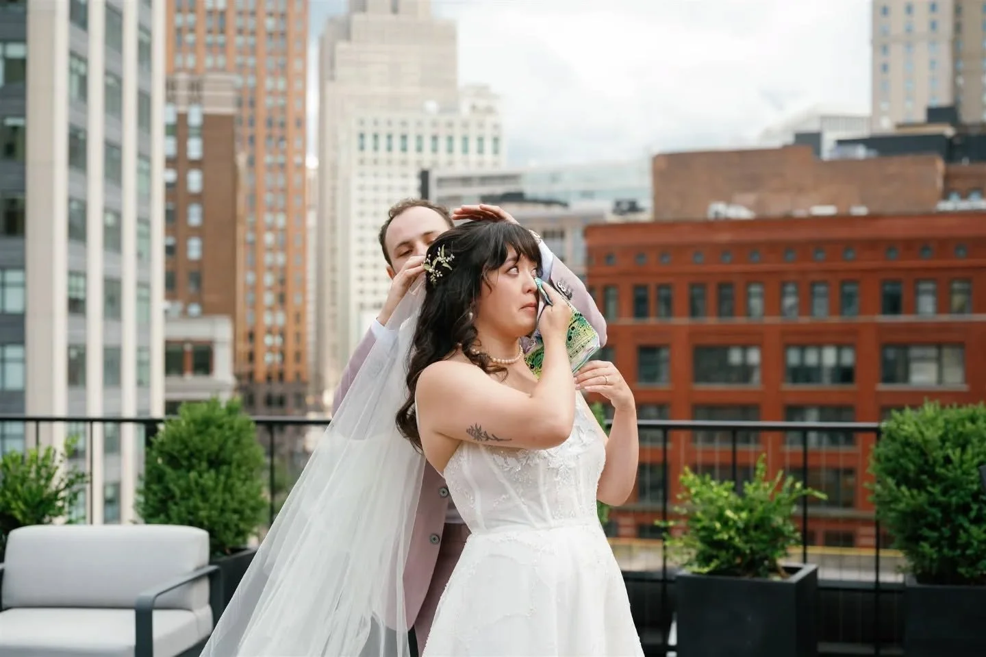 On the rooftop of @downtownsynagogue with the Detroit skyline behind them, Stephanie and Charlie added their own twist to the Badeken after signing their ketubah. Charlie placed Stephanie&rsquo;s veil on her head, and she placed his kippah on his, sh