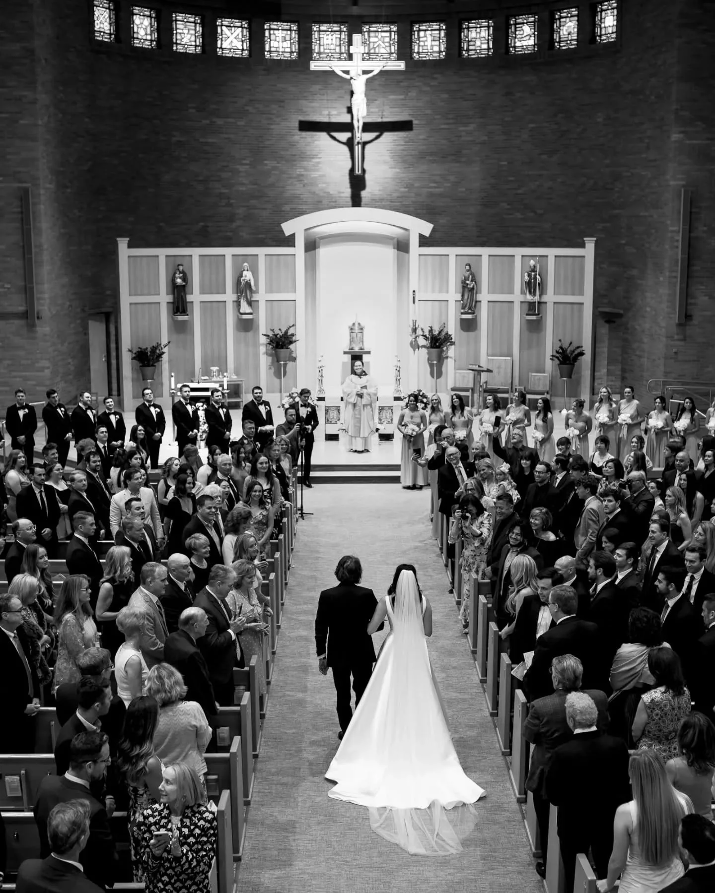 One of my favorite photos. A pulled-back perspective that holds all the anticipation and emotion seconds before Brielle and John say their vows to each other.

[Michigan wedding photographer, Catholic wedding ceremony, Michigan wedding, black and whi