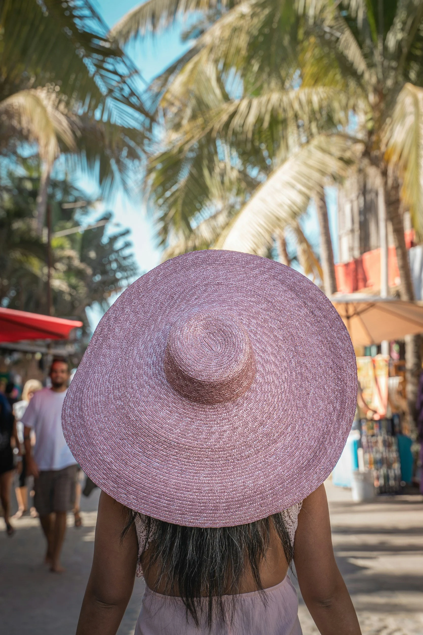 Surfboards and beach culture in Sayulita Mexico located walking distance from Hotel Sayulita Central.

Woman exploring downtown Sayulita near Hotel Sayulita Central surrounded by palm trees, local shops, and beach town atmosphere.