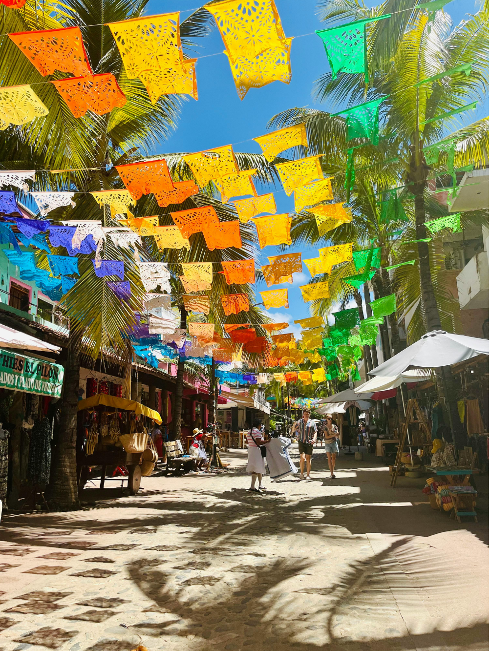 Colorful papel picado decorations in downtown Sayulita near Hotel Sayulita Central, local shops, restaurants, and cafés.