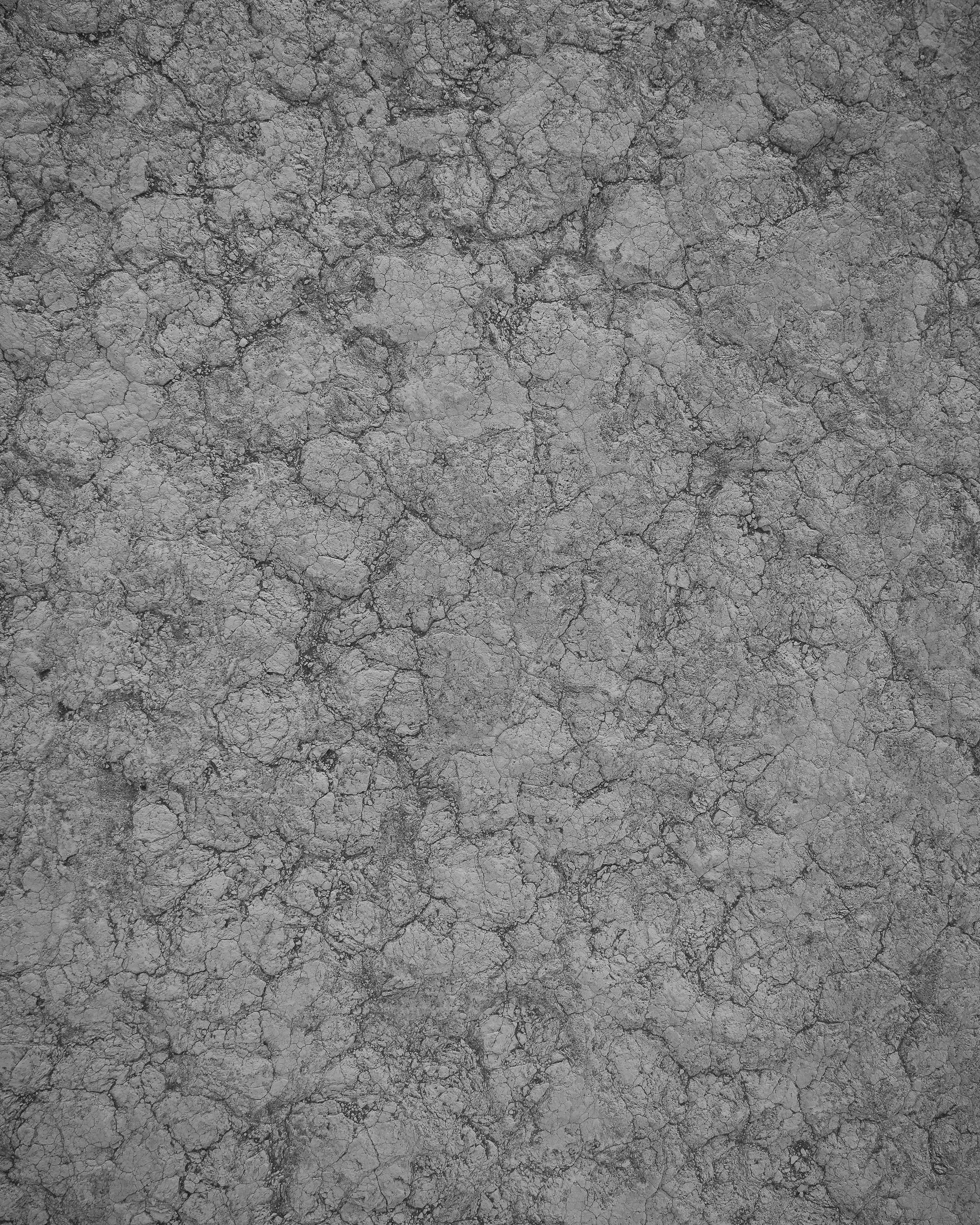 Cracked dry gray earth or concrete surface.