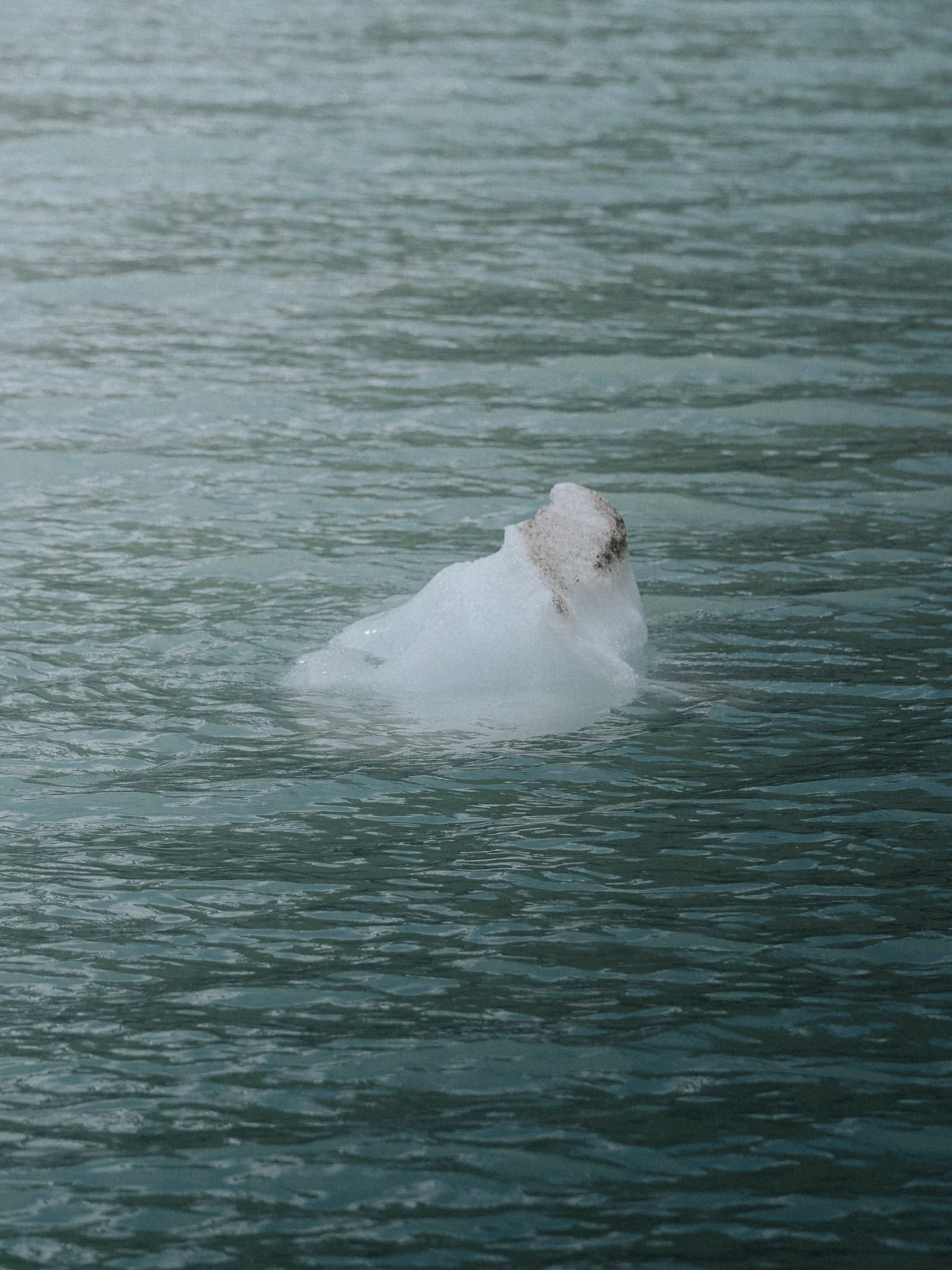 A small iceberg floating in the ocean.