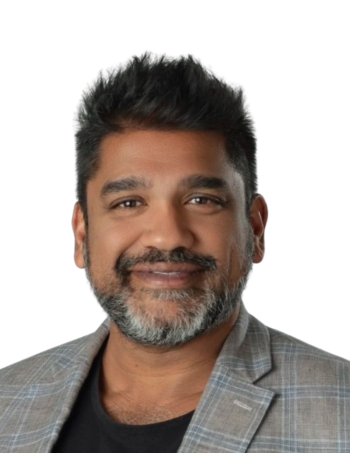A middle-aged man with dark hair, a beard with grey, smiling, wearing a grey checked blazer over a black shirt against a white background.