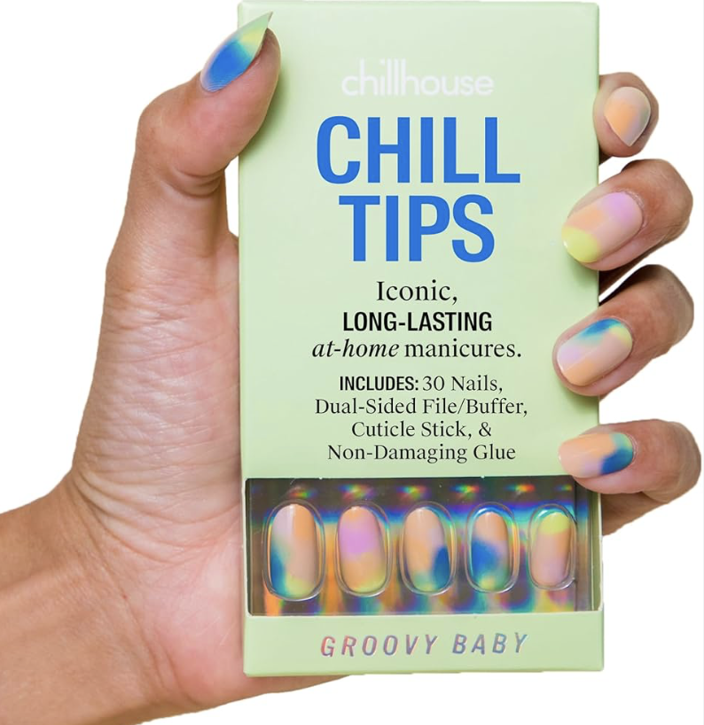 A hand holding a box of Chill Tips nail products with pastel and rainbow-colored manicures. The box is light green with blue text that reads "Chill Tips" and describes long-lasting at-home manicures.