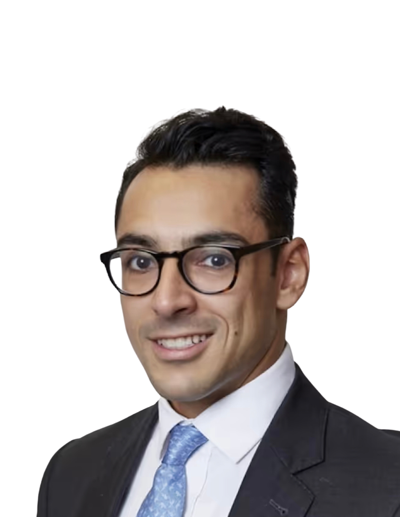 A man with glasses wearing a dark suit, white shirt, and light blue tie, smiling, with a plain white background.