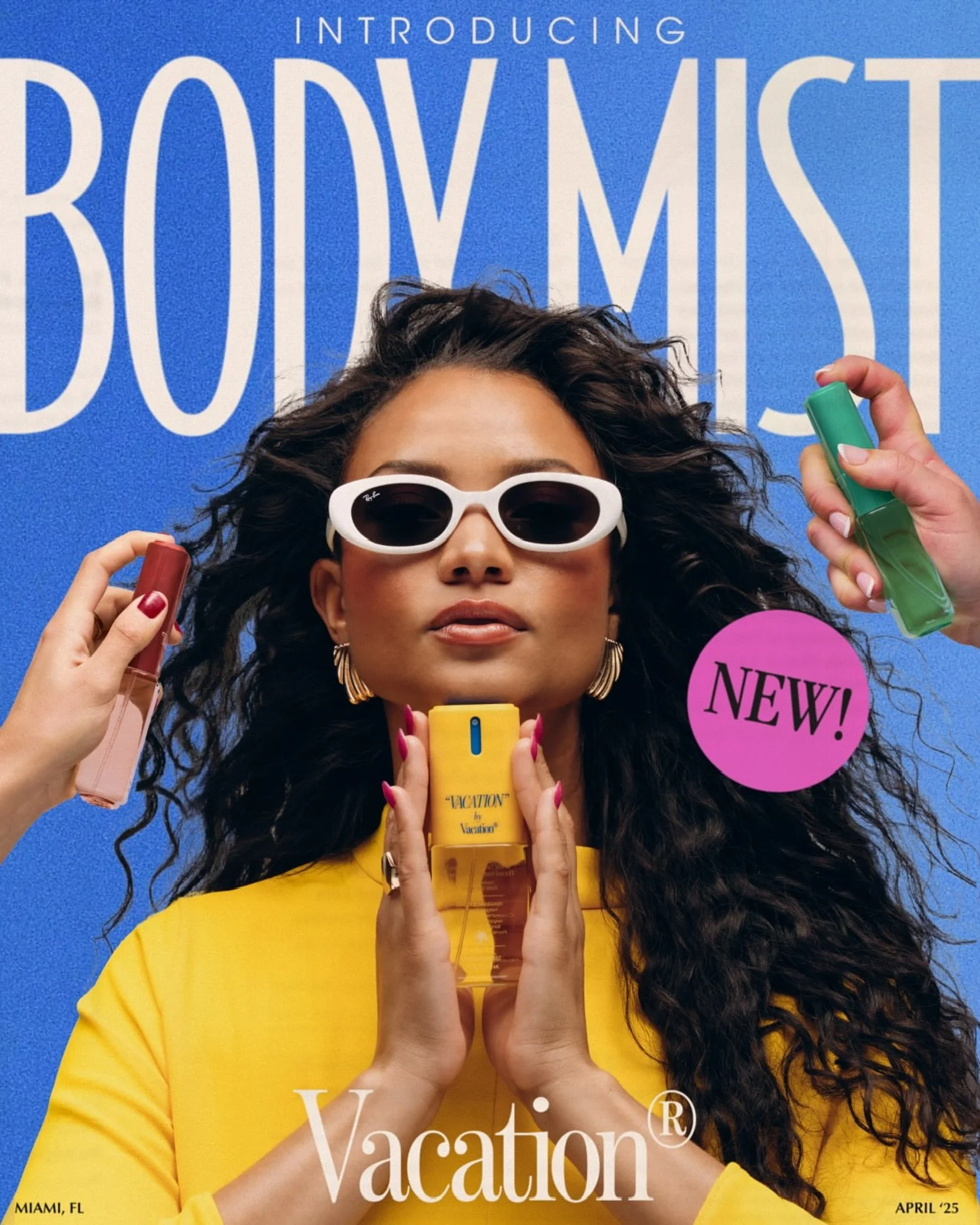 A woman with curly hair wearing white sunglasses and a yellow top, holding a yellow perfume bottle. She has a confident expression and is surrounded by colorful tubes of makeup or skincare. Los Angeles premiere hair and makeup artist, Amber Rose.