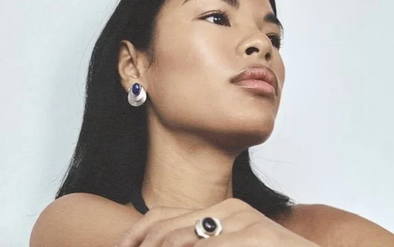 Beauty portrait pairing a pearl drop earring with a statement ring, soft upward gaze, jewelry editorial hair and makeup by Los Angeles artist Amber Rose.