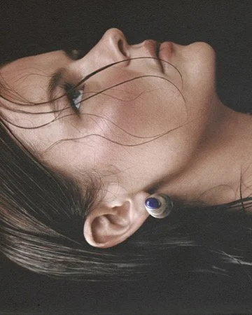Artistic double-exposure beauty portrait with fine line overlays and a delicate ear cuff, avant-garde styling by Los Angeles artist Amber Rose.
