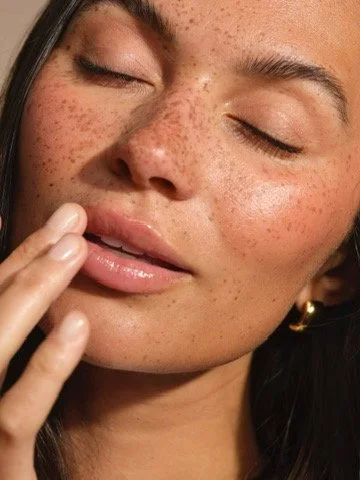 Close up image of model with luminous skin. Hair and Makeup by Amber Rose