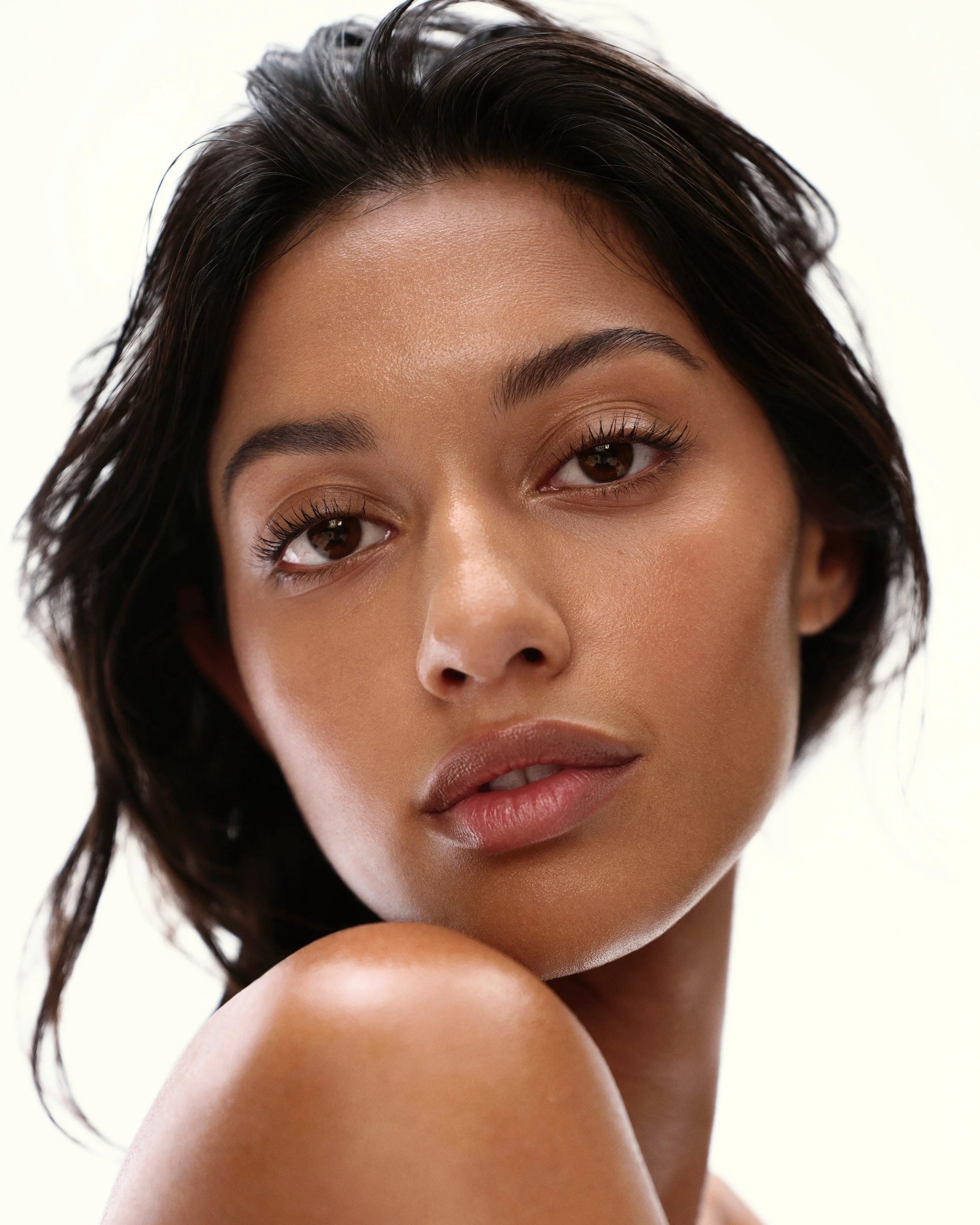 Model with natural curls and fresh, glowing skin for the ZO Skin Health Sunshade campaign. Hair and makeup by Amber Rose.