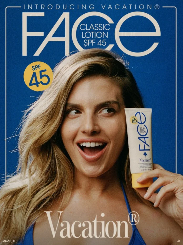A woman with long blonde hair holding a box of face lotion with SPF 45. She is smiling and looking to her right against a blue background with the product branding. Hair and makeup by Amber Rose.