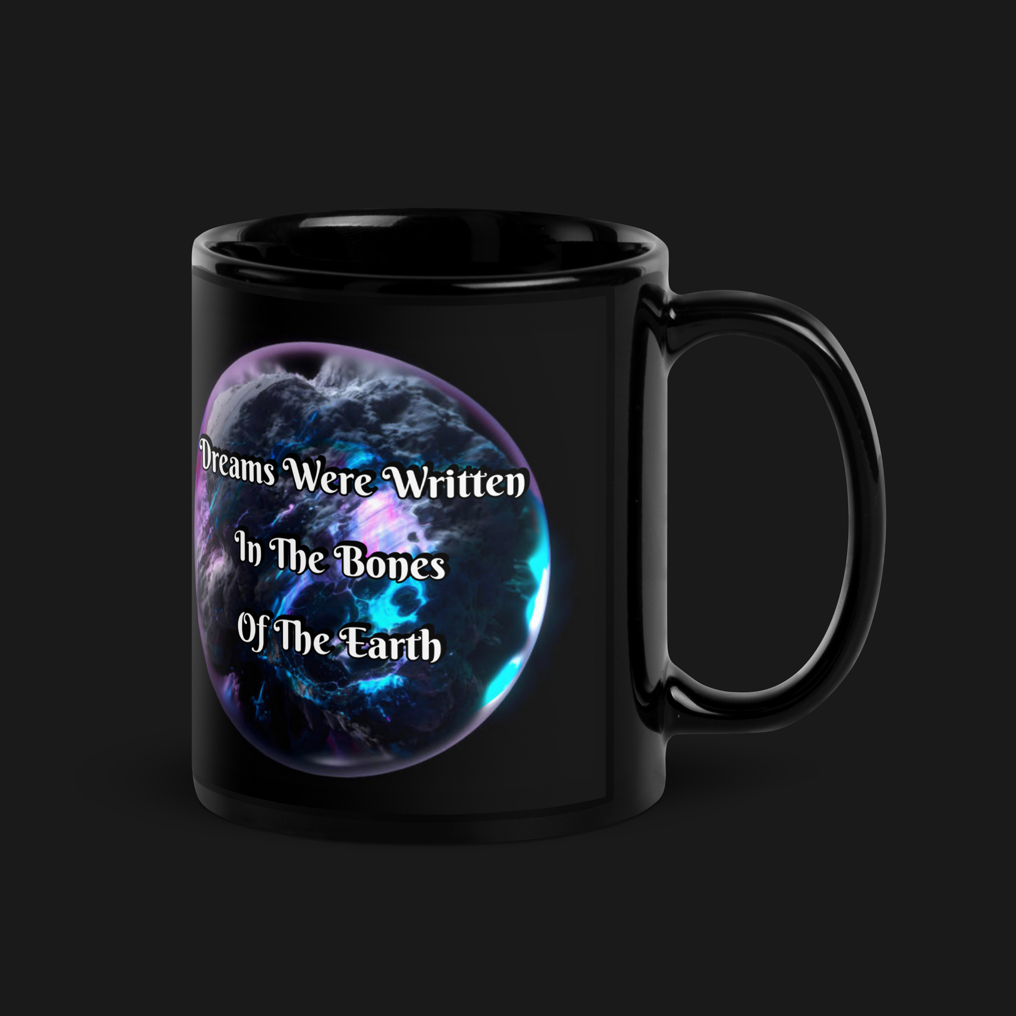 Black ceramic mug from the WPB Emporium Onyx Collection featuring a cosmic design with the phrase “Dreams Were Written in the Bones of the Earth.”