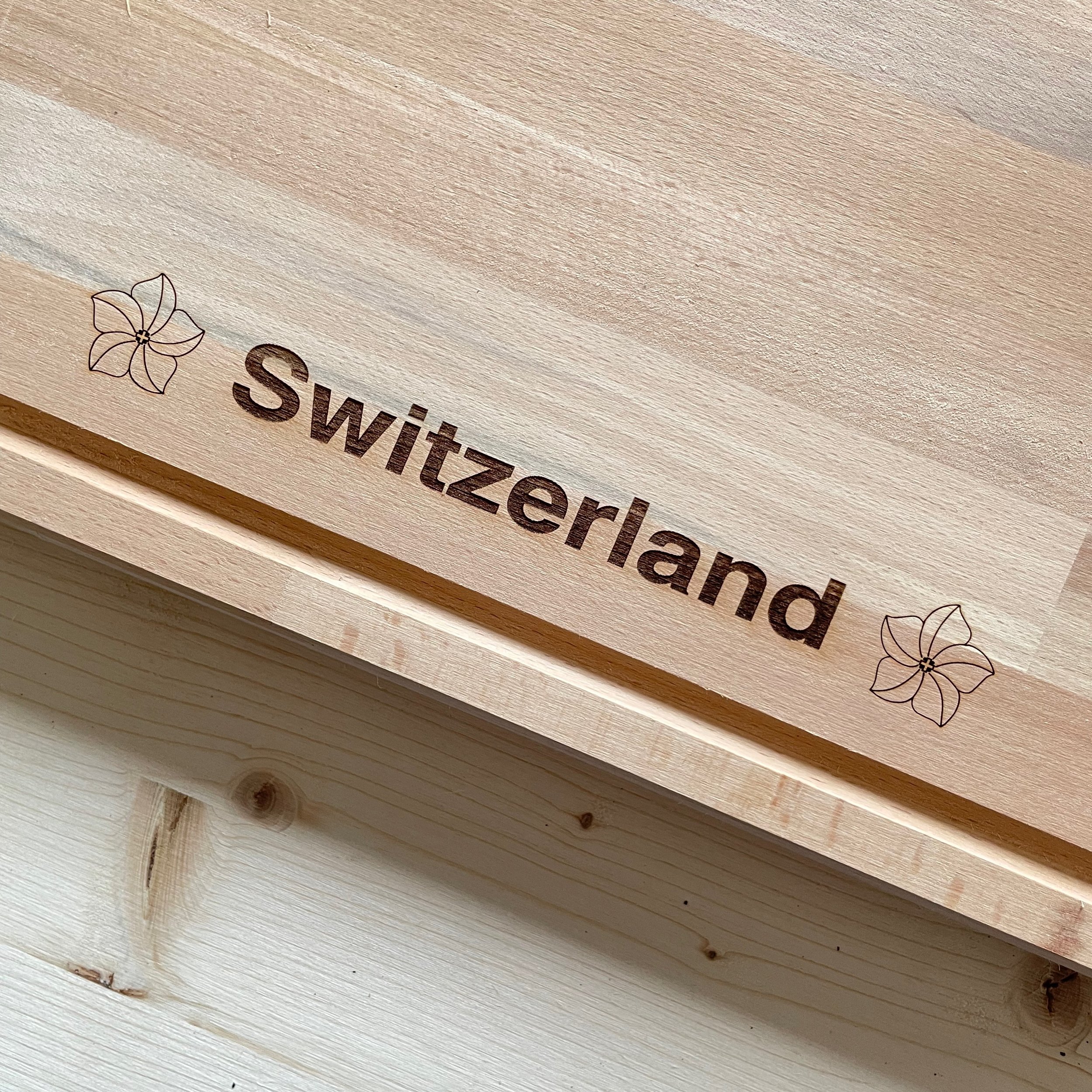 Beechwood cutting board Engraved with "Switzerland" and the iconic Swiss Alps. Close up of engraving.