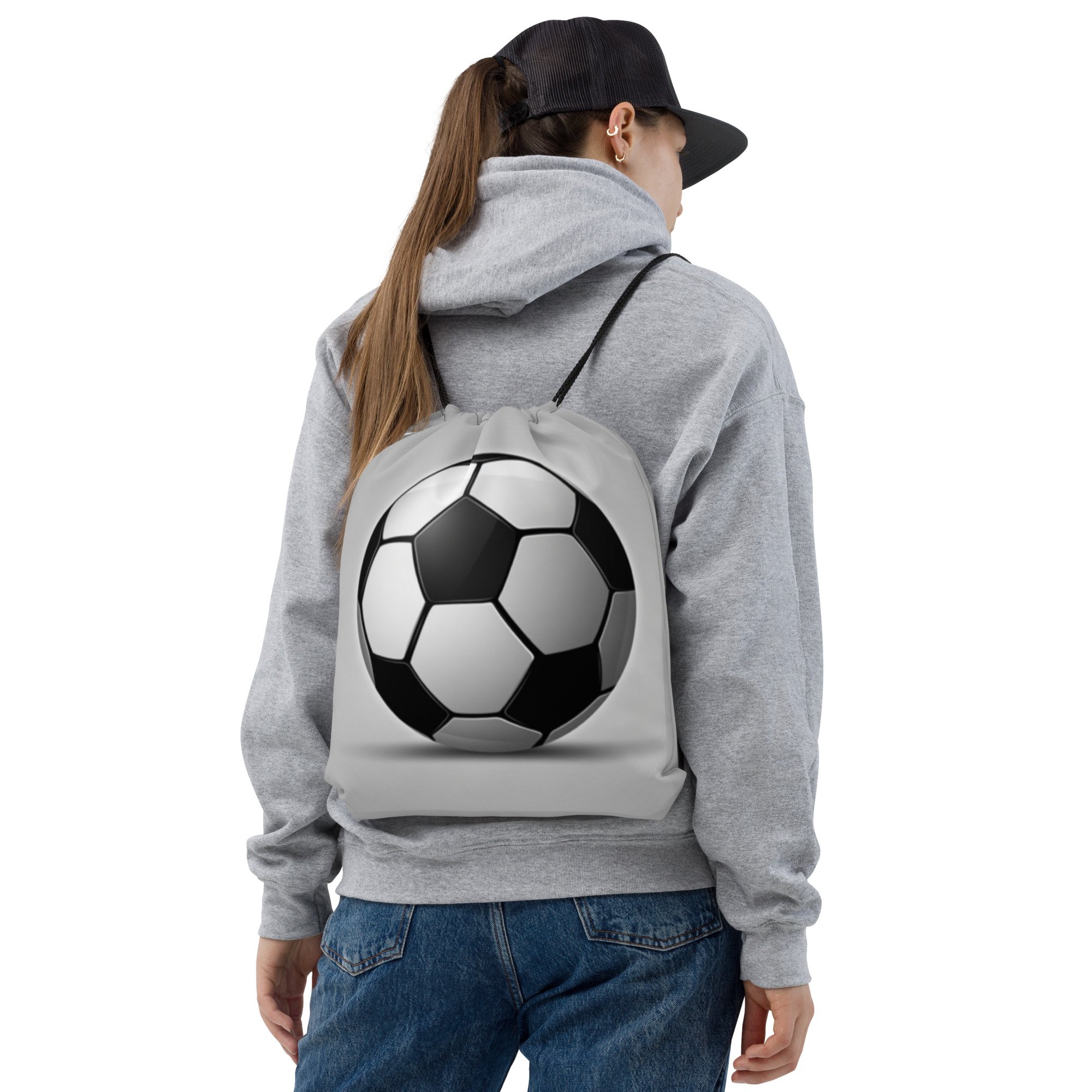 A person wearing the Beautiful Game Soccer ball drawstring backpack.