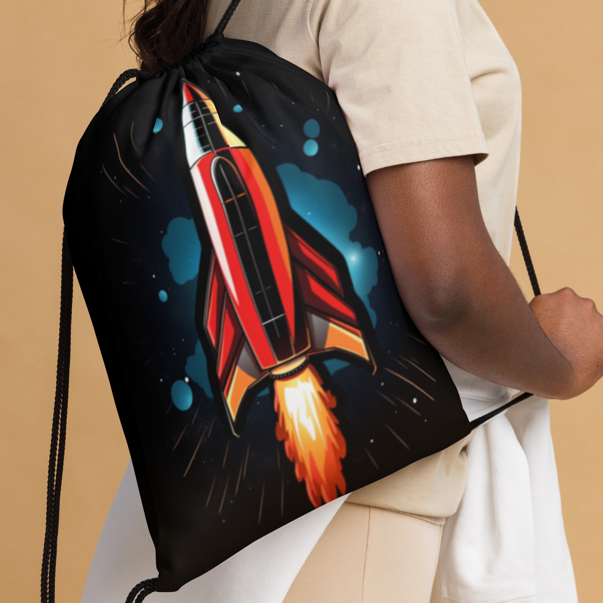 The red rocket ride drawstring back pack being worn on a shoulder.
