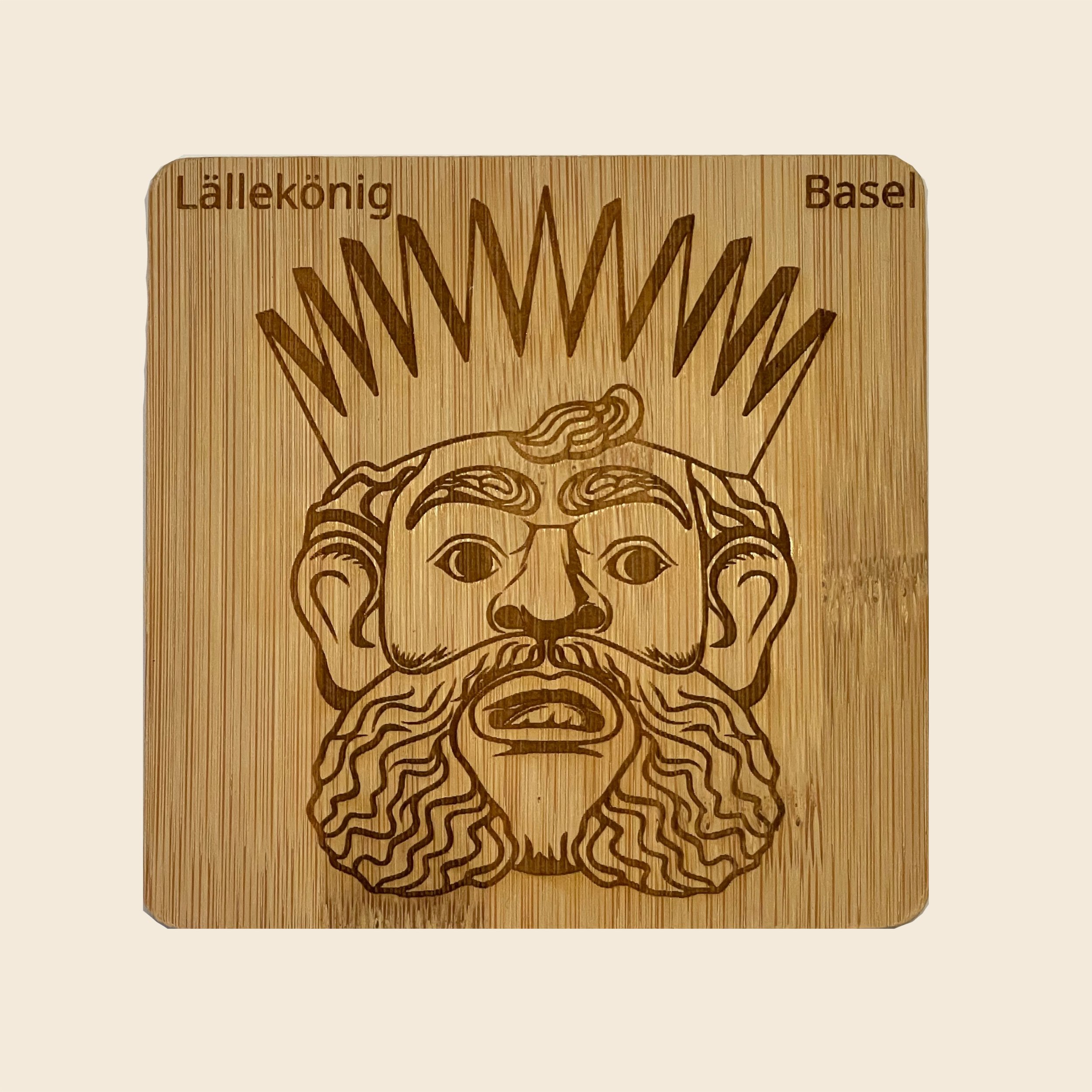 Square bamboo coaster with the etched image of the Lällekönig of Basel, representing the city's heritage.