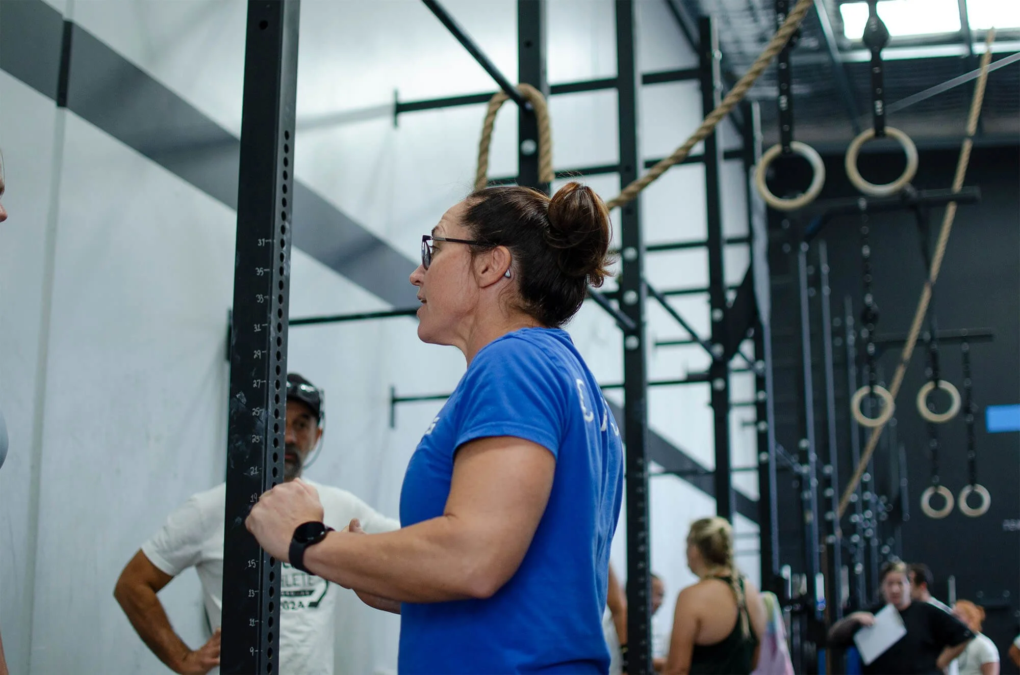 Affiliate owner of CrossFit TARIS, Lisa Lake chatting with a member, and fellow affiliate owner Shane Lake is stood in the backgorund.