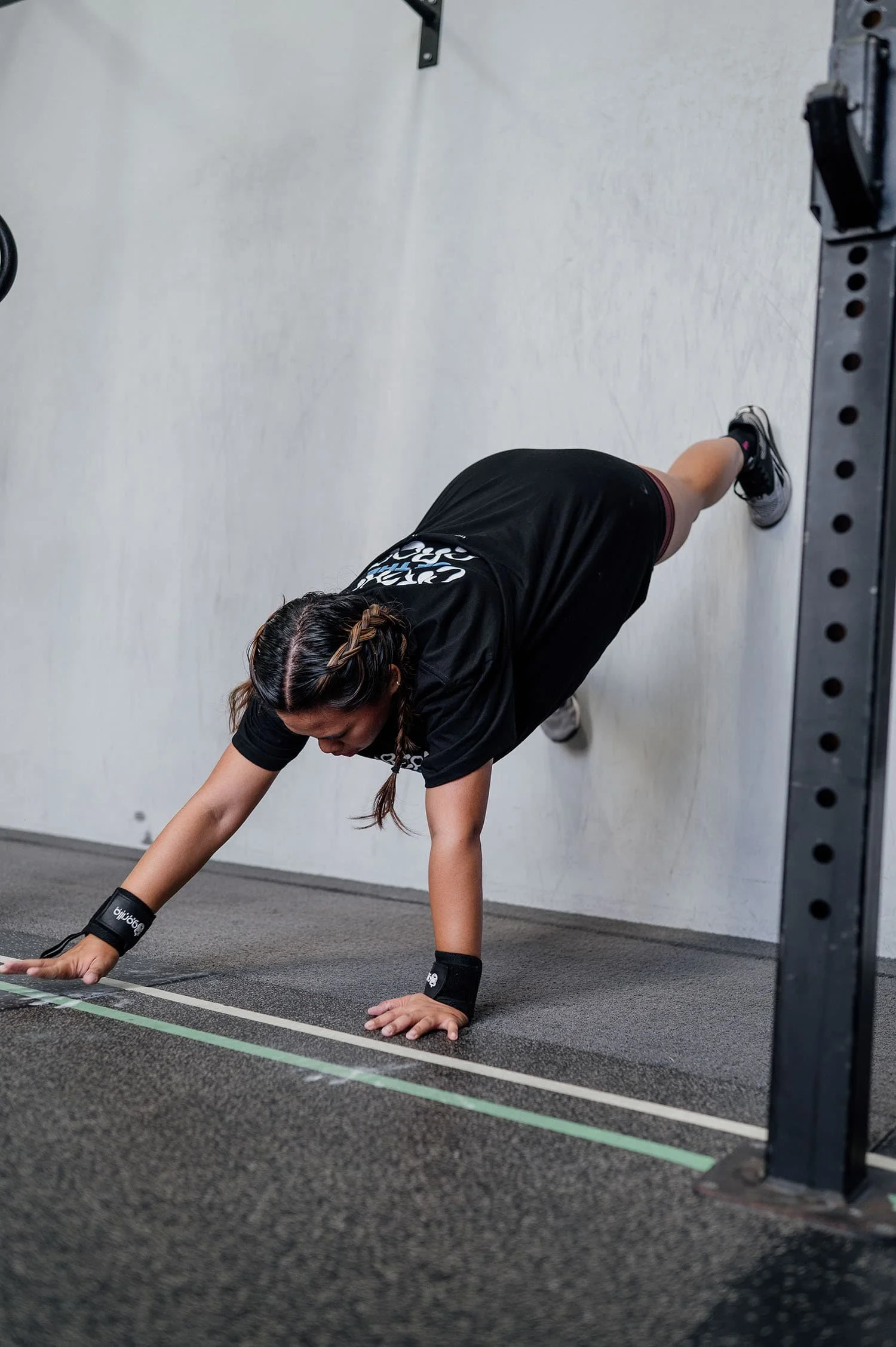 Female member doing a wall walk during a workout at CrossFit TARIS.