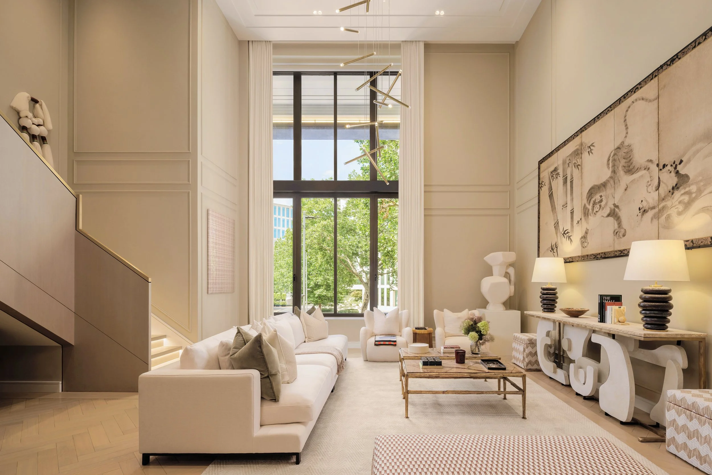 Double-height living room with tall windows in a three-bedroom apartment at Holland Park Gate, Kensington, London