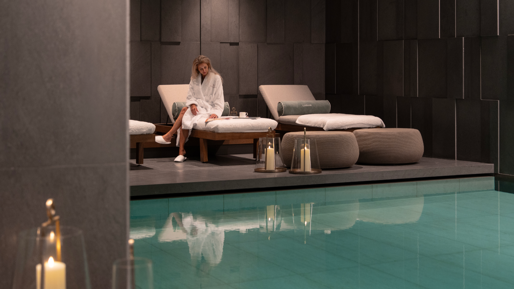Resident relaxing on a lounger beside the 25-metre swimming pool at Holland Park Gate health club, Kensington, London