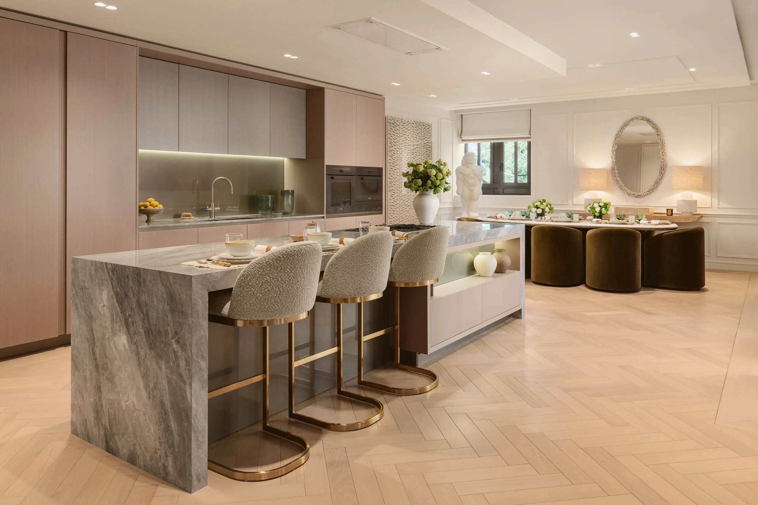 Kitchen with marble island and bar stools in a two-bedroom apartment at Holland Park Gate, Kensington, London