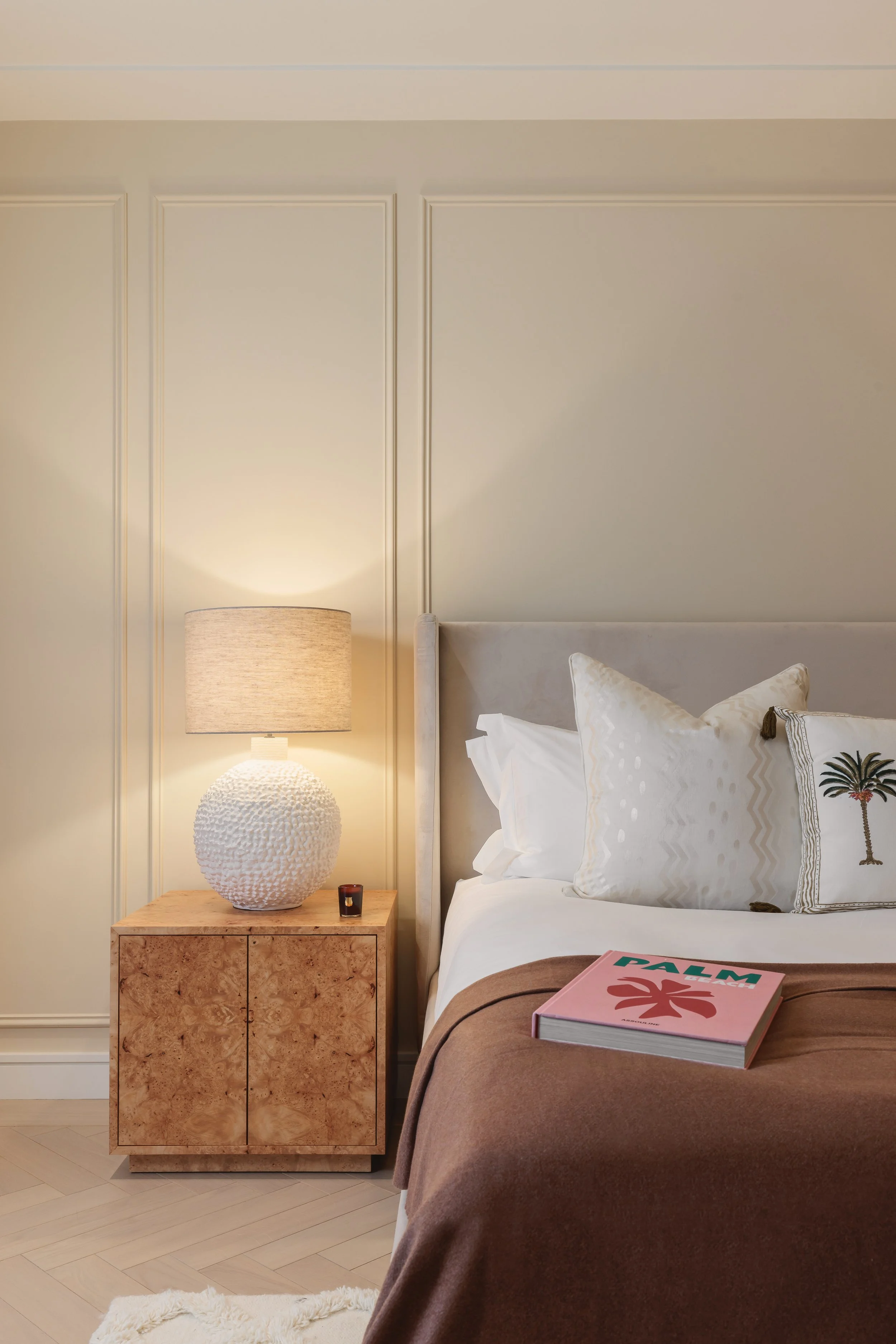 Bedroom with upholstered headboard and bedside lamp in a two-bedroom apartment at Holland Park Gate, Kensington, London