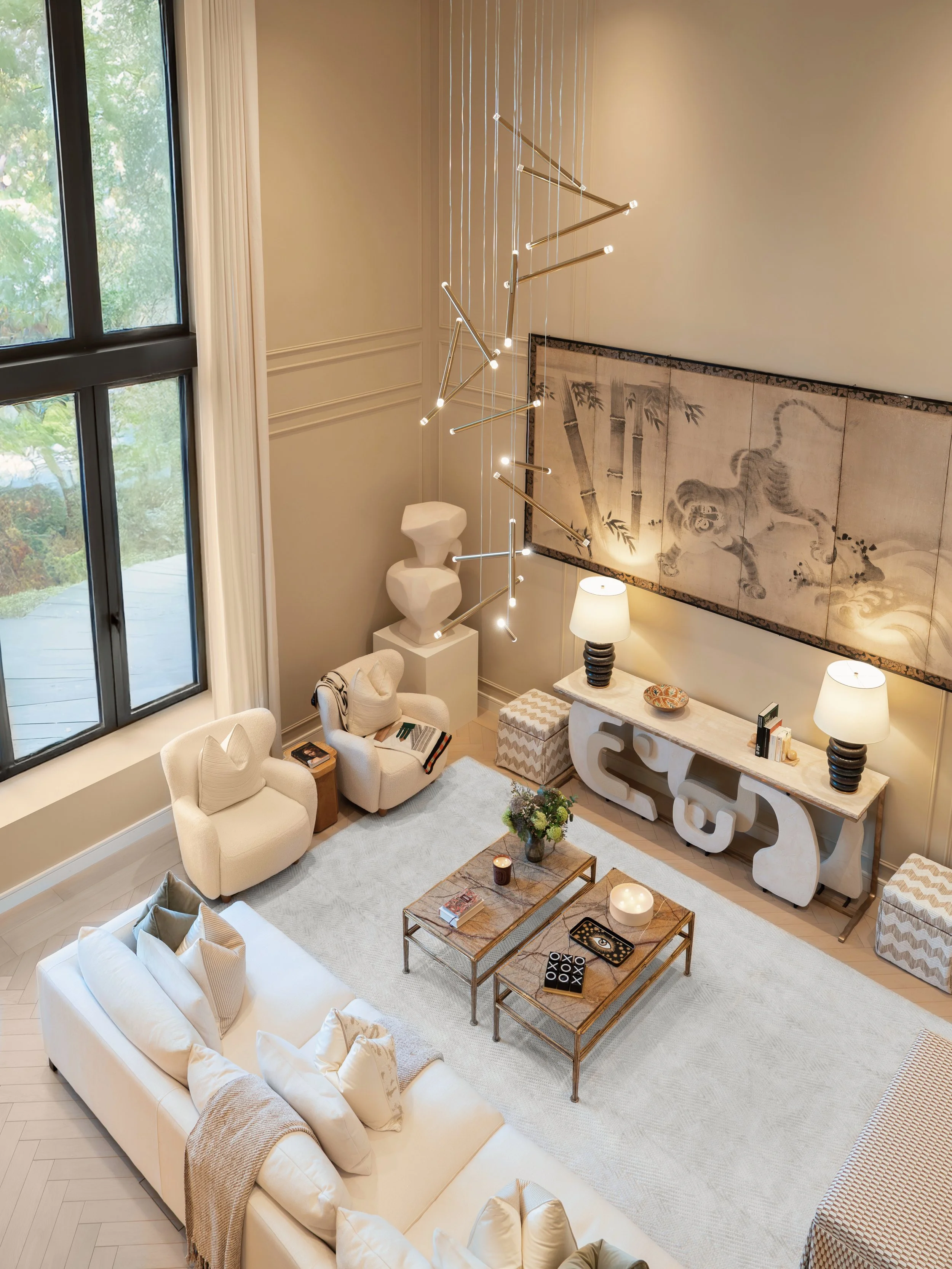 Living room with sculptural artwork and coffee tables in a three-bedroom apartment at Holland Park Gate, Kensington, London