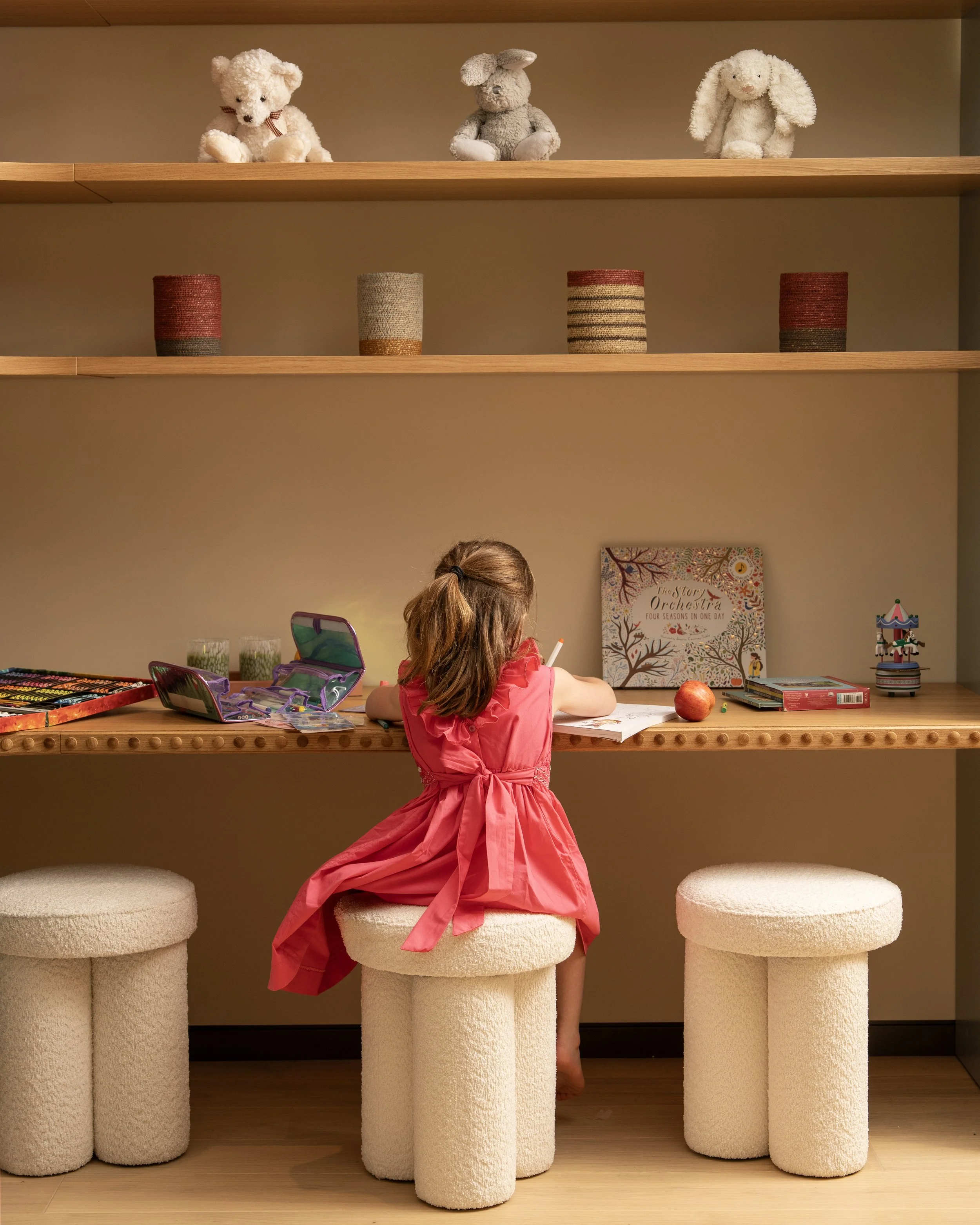 Child drawing at a desk in the residents' Kids Club at Holland Park Gate, Kensington, London