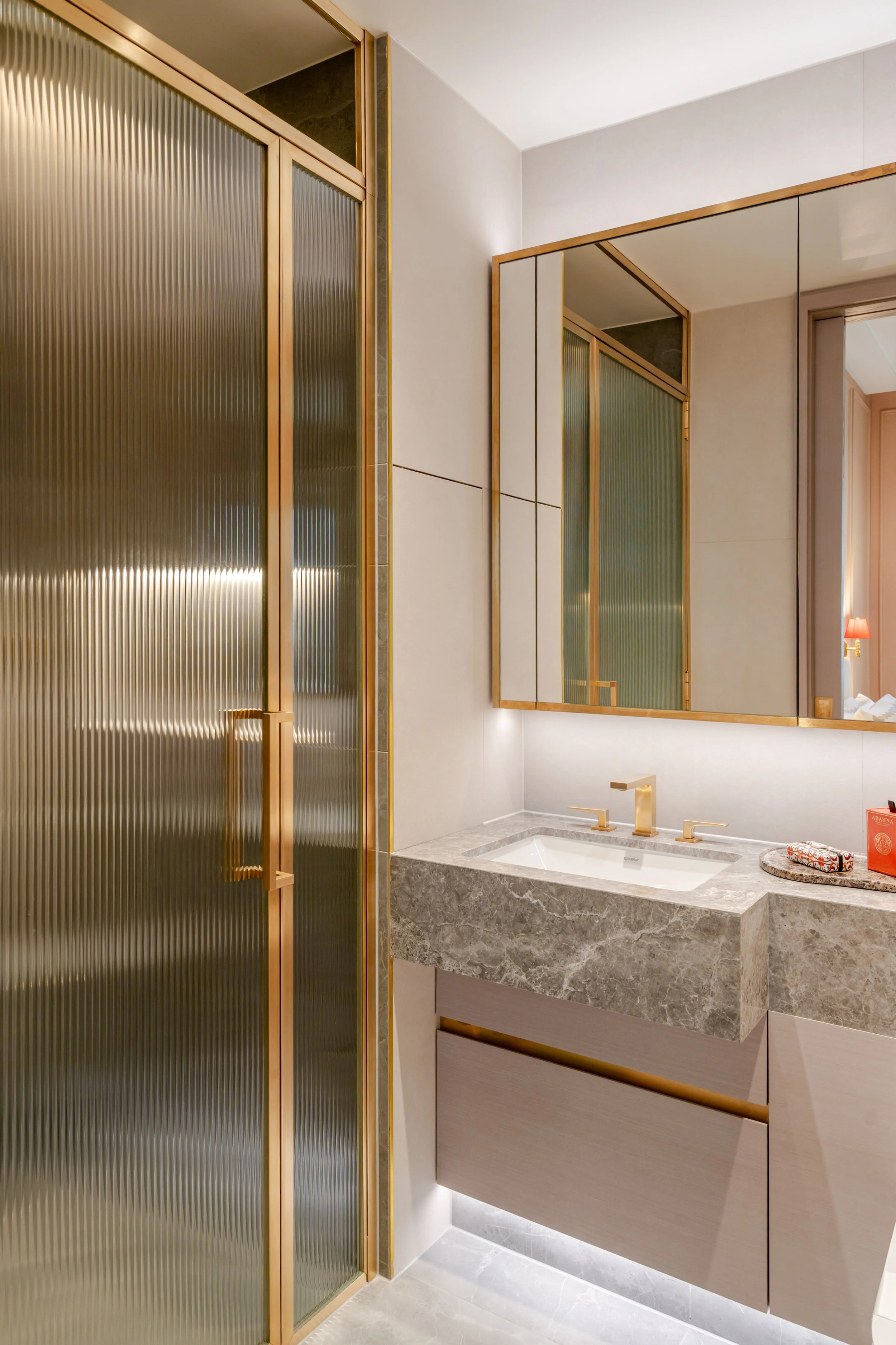 Bathroom with fluted glass shower and marble vanity in a one-bedroom apartment at Holland Park Gate, Kensington, London