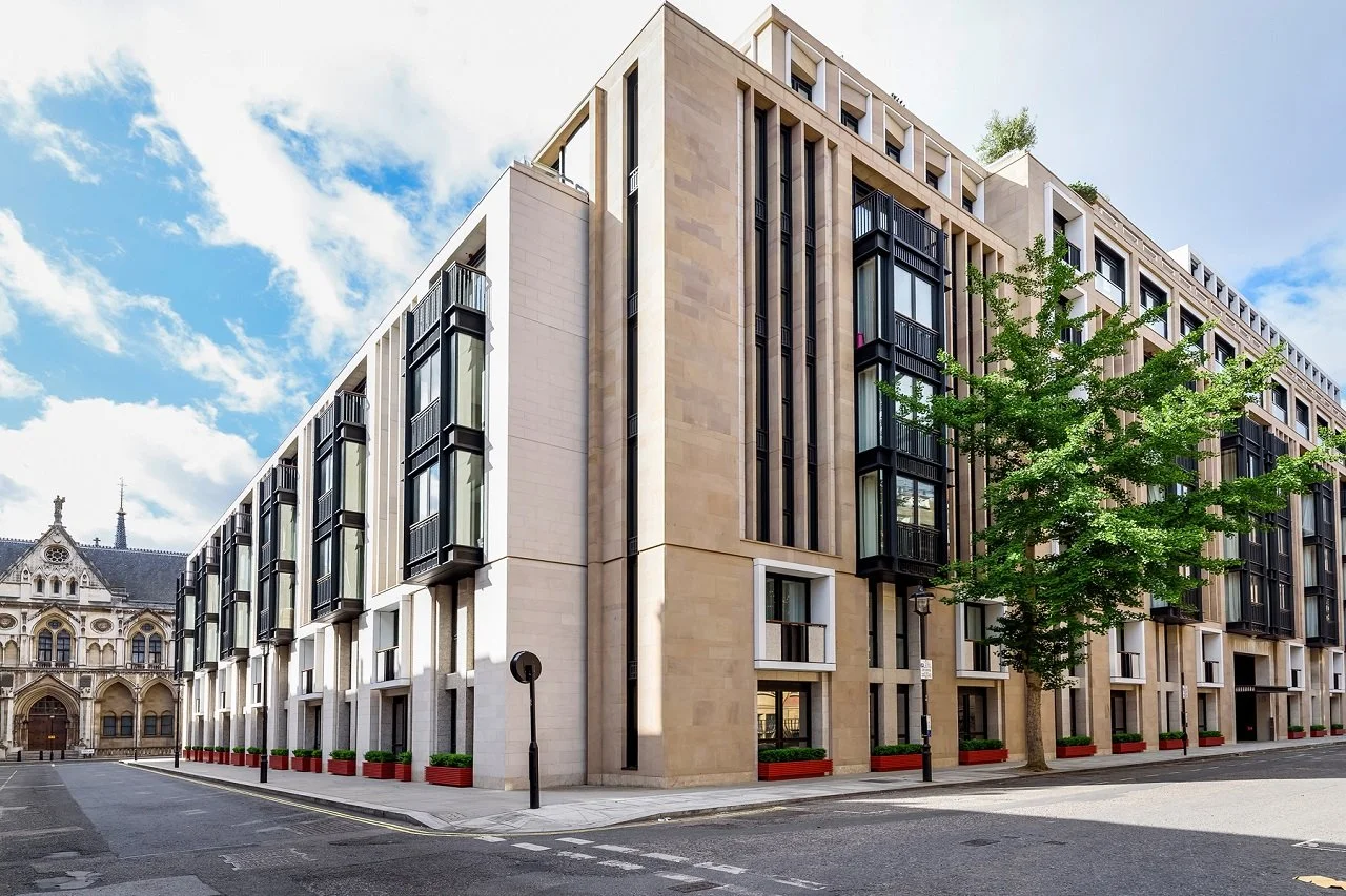 Stone facade with black bay windows at Lincoln Square, a Lodha residential development in Holborn, London