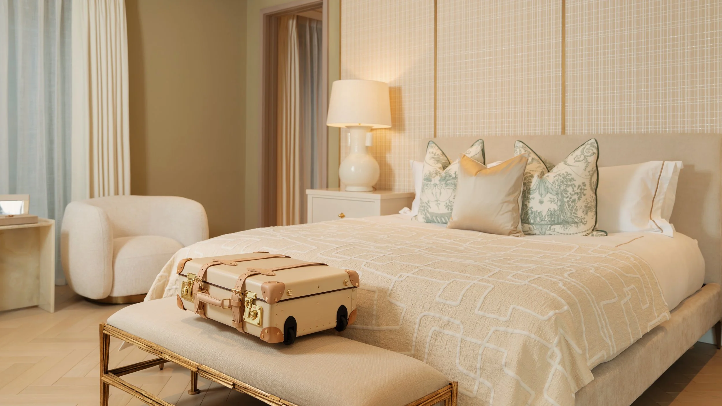 Globetrotter suitcase at the foot of a bed, ready for arrival in a serviced residence at Holland Park Gate, Kensington, London
