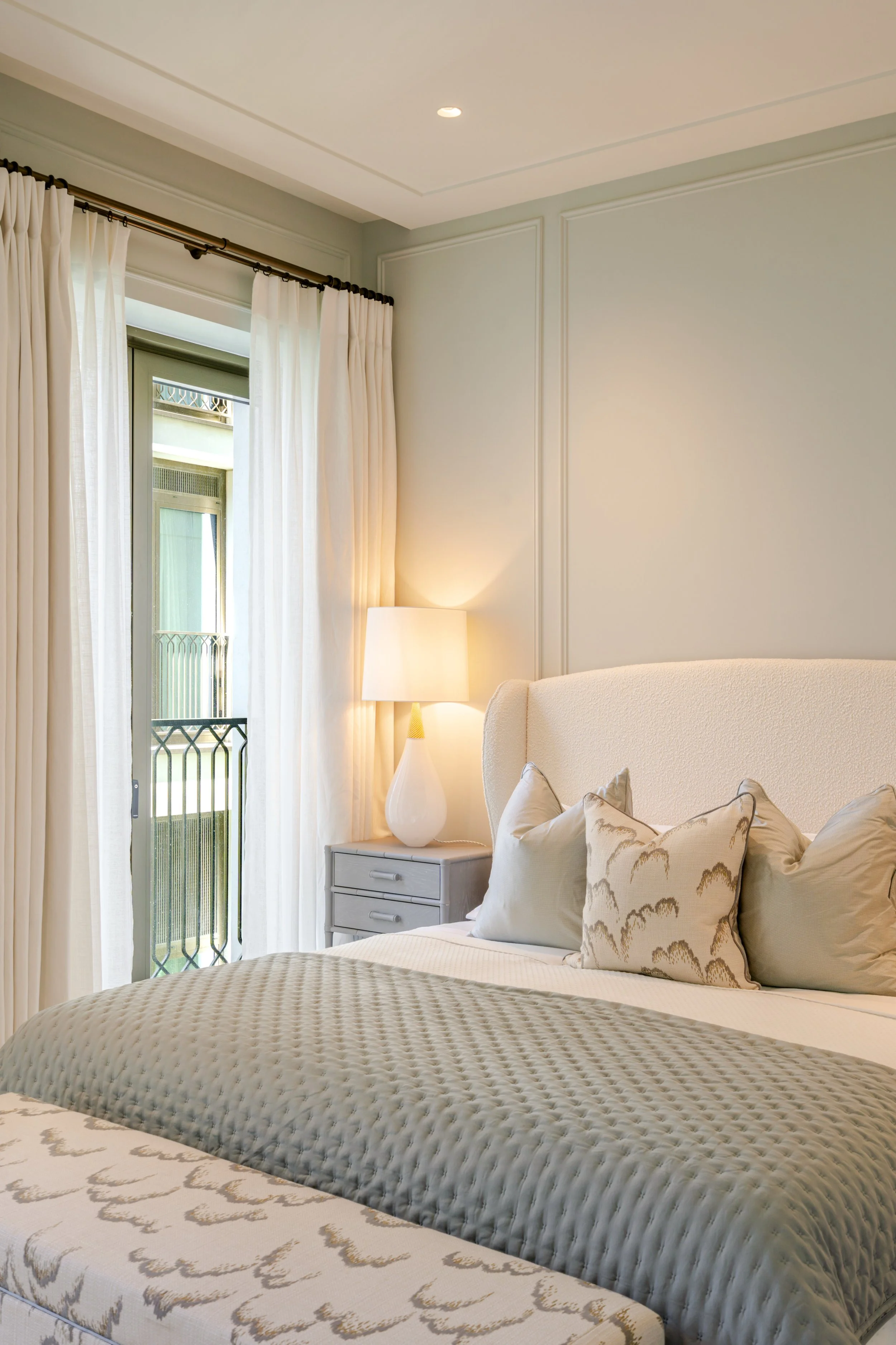 Light-filled bedroom with full-height windows in a one-bedroom apartment at Holland Park Gate, Kensington, London
