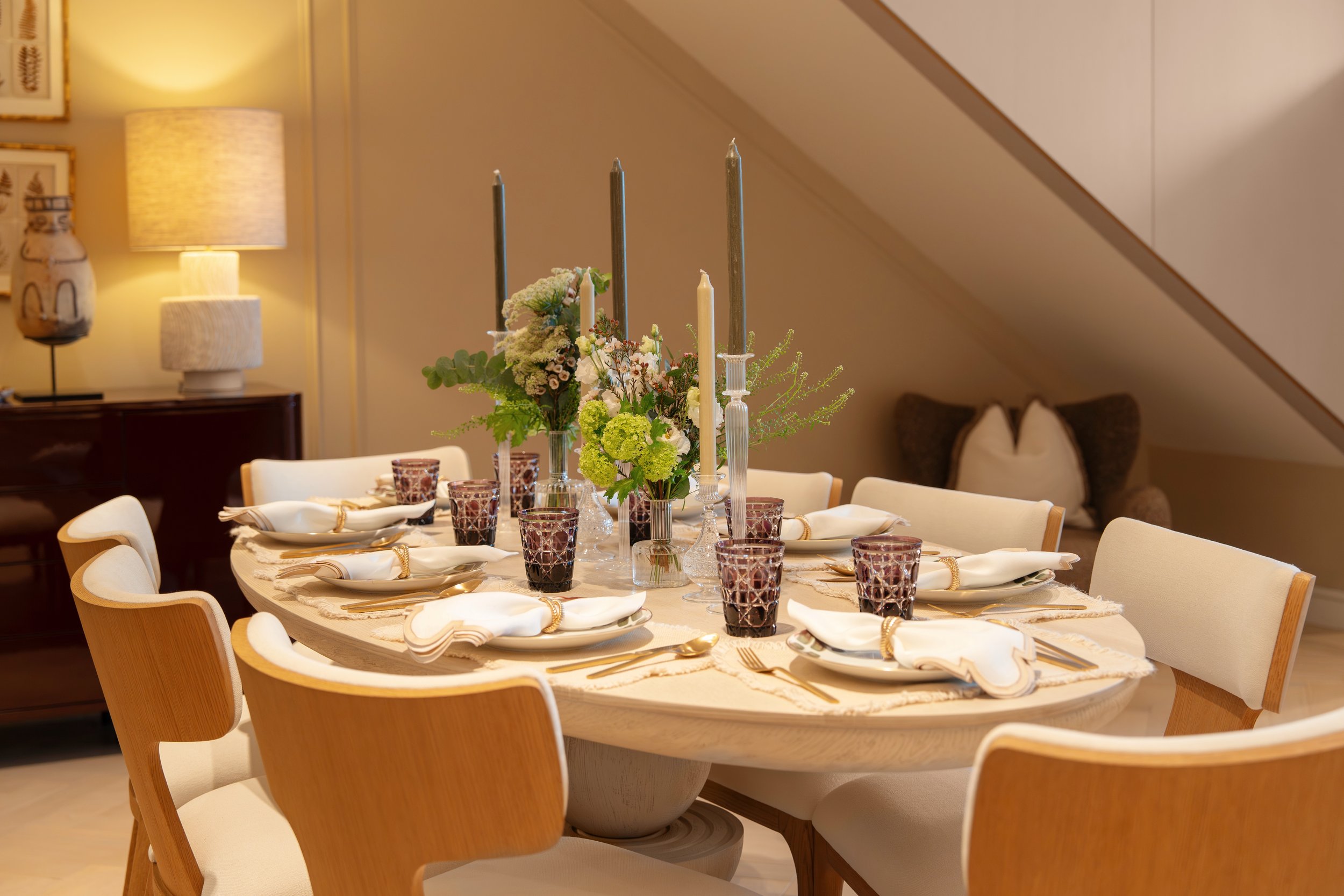 Candlelit dining table set for eight in a luxury residence at Holland Park Gate, Kensington, London