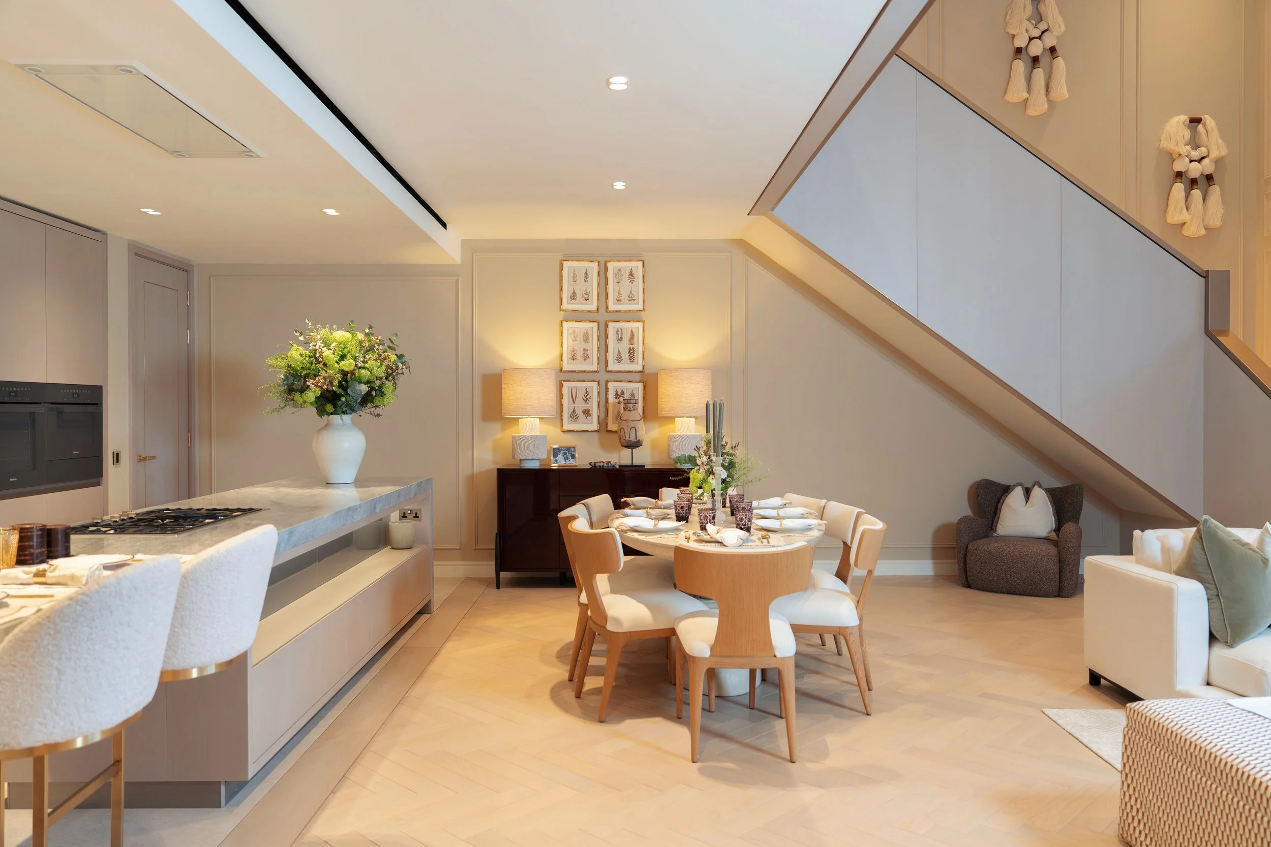 Dining area beneath the staircase in a three-bedroom apartment at Holland Park Gate, Kensington, London