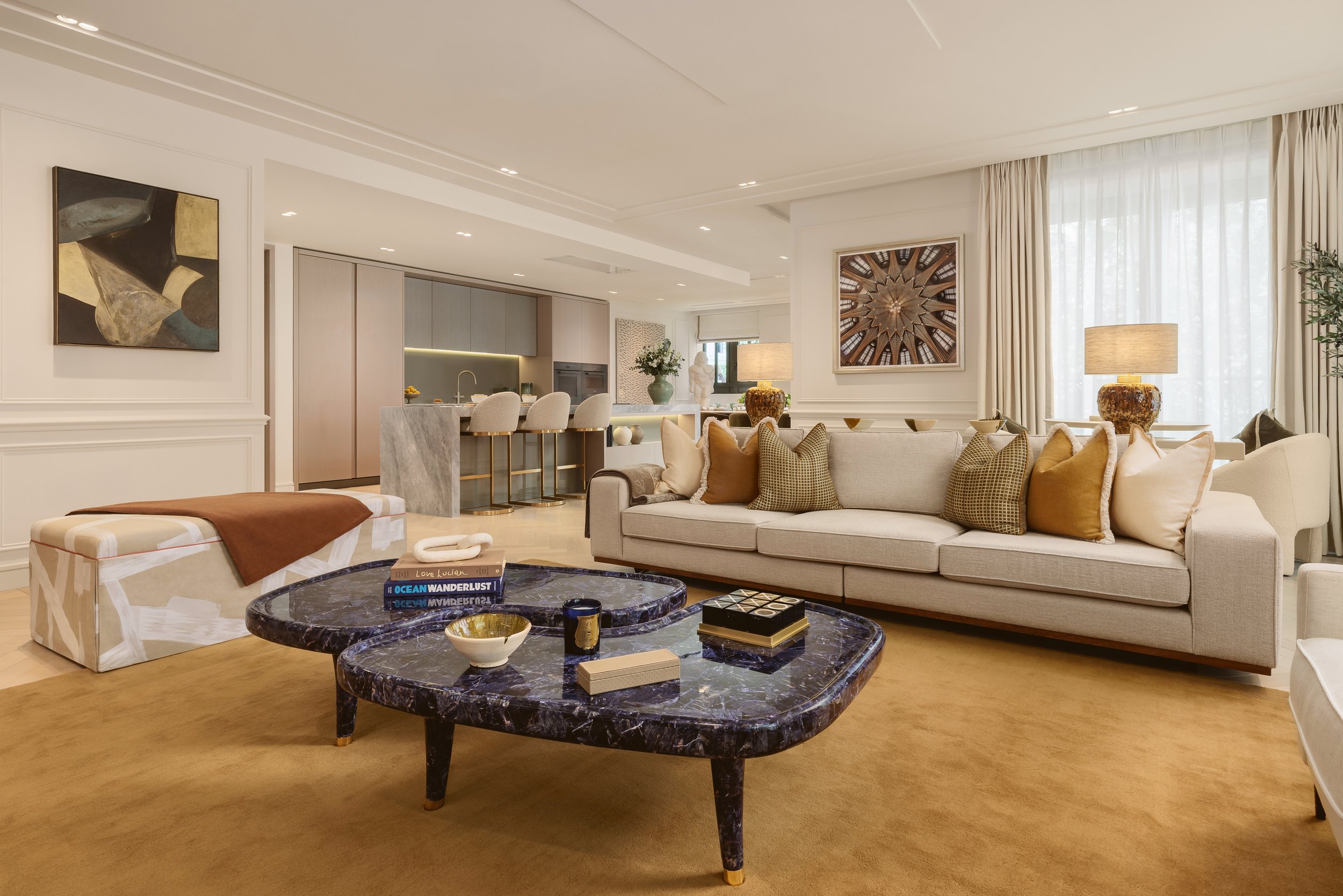 Open-plan living room with stone coffee table in a two-bedroom apartment at Holland Park Gate, Kensington, London