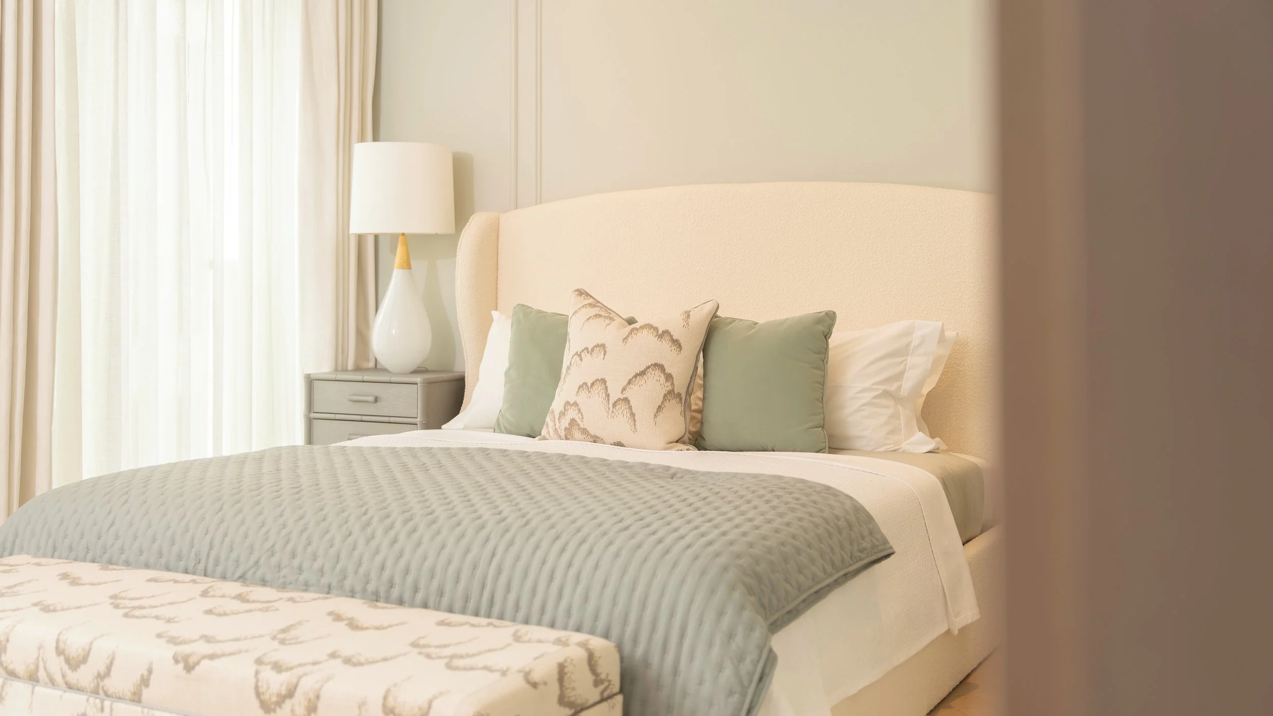 Bedroom with upholstered headboard and soft furnishings in a one-bedroom apartment at Holland Park Gate, Kensington, London