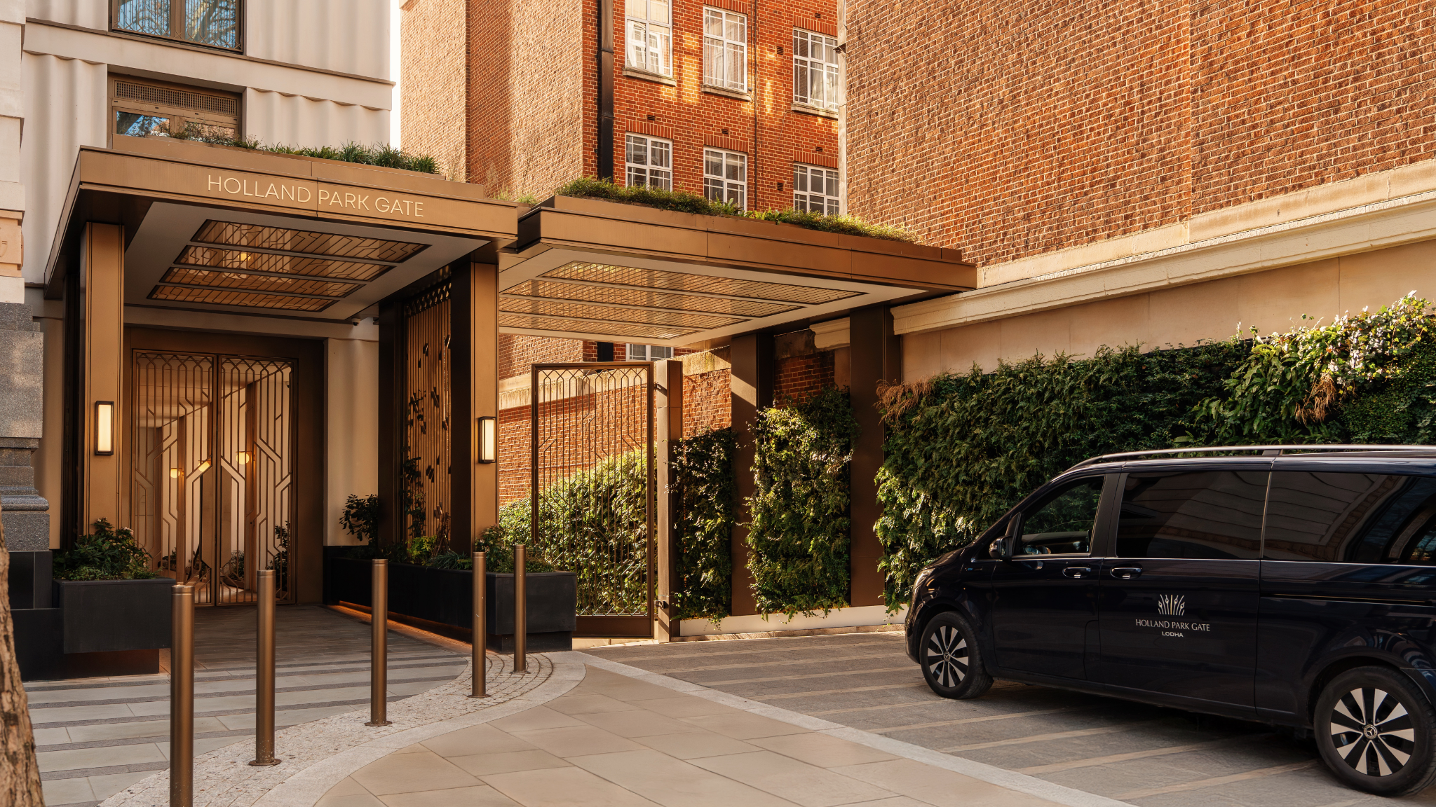 Gated private entrance with green walls and the branded Holland Park Gate house car, Kensington, London