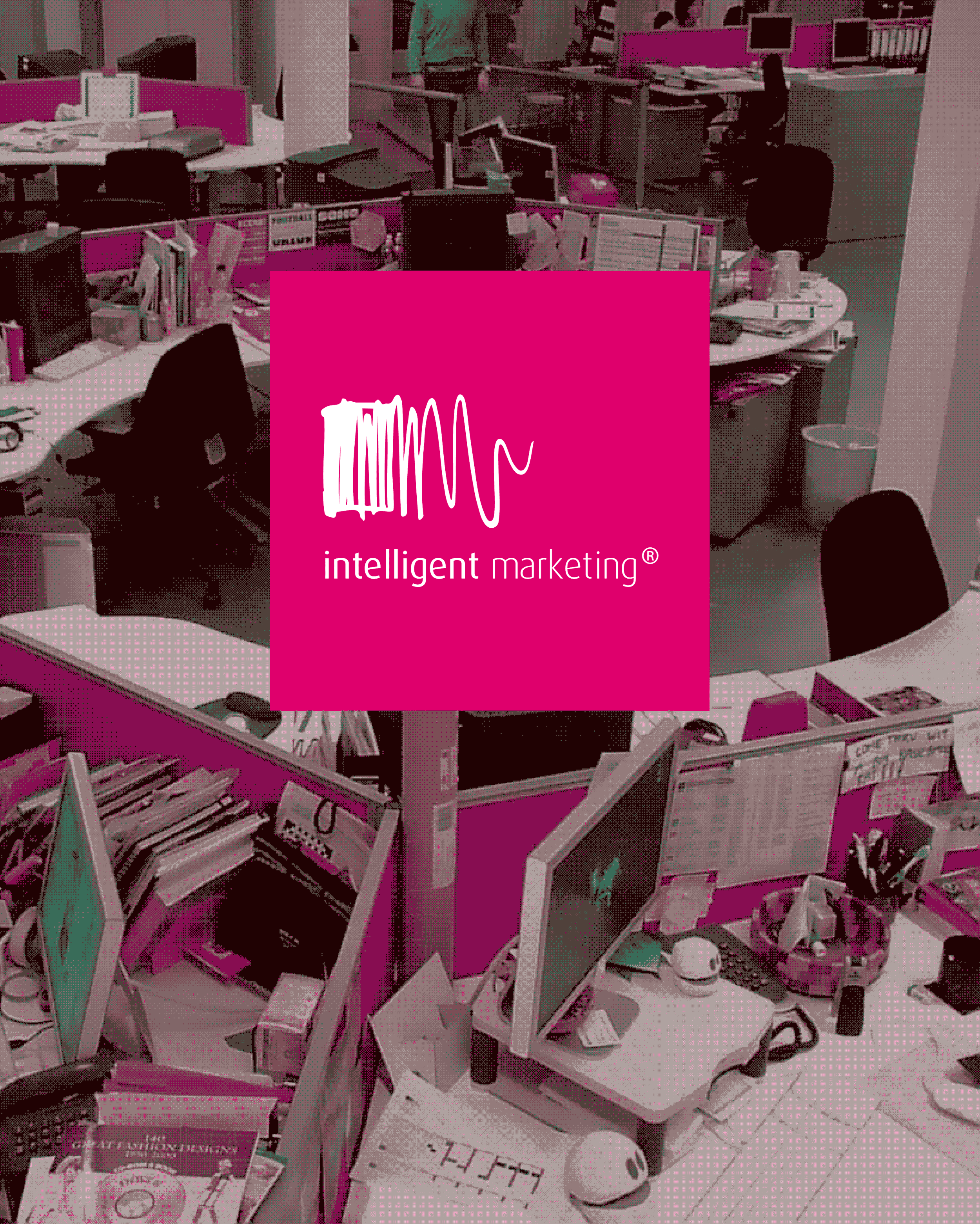 A stylised view from above, looking across the studio at IM. The colours have been limited shifted to pick out the agency brand signature pink. There is a square of pink in the middle with the IM logo in white.