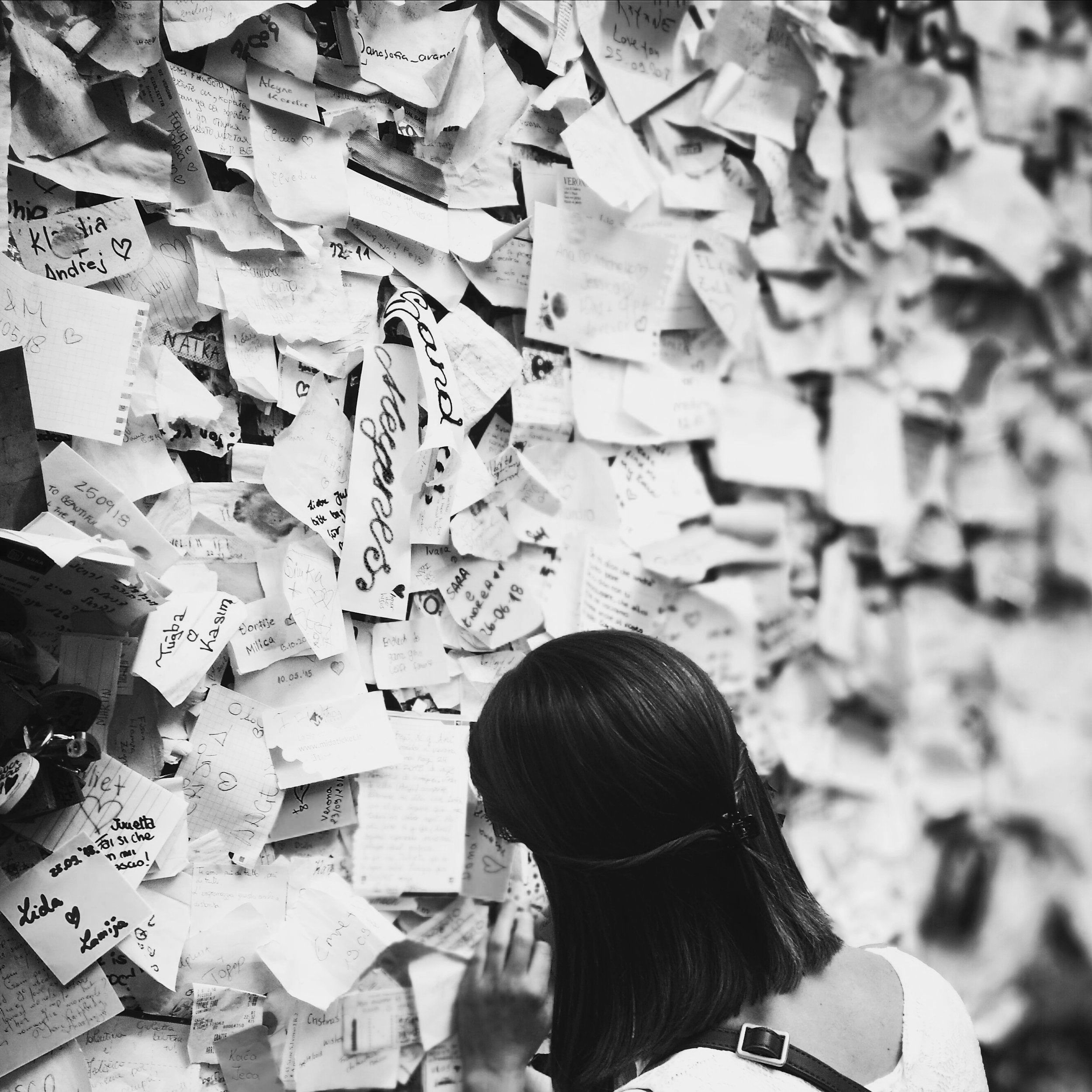 Woman in front of wall of post-it notes