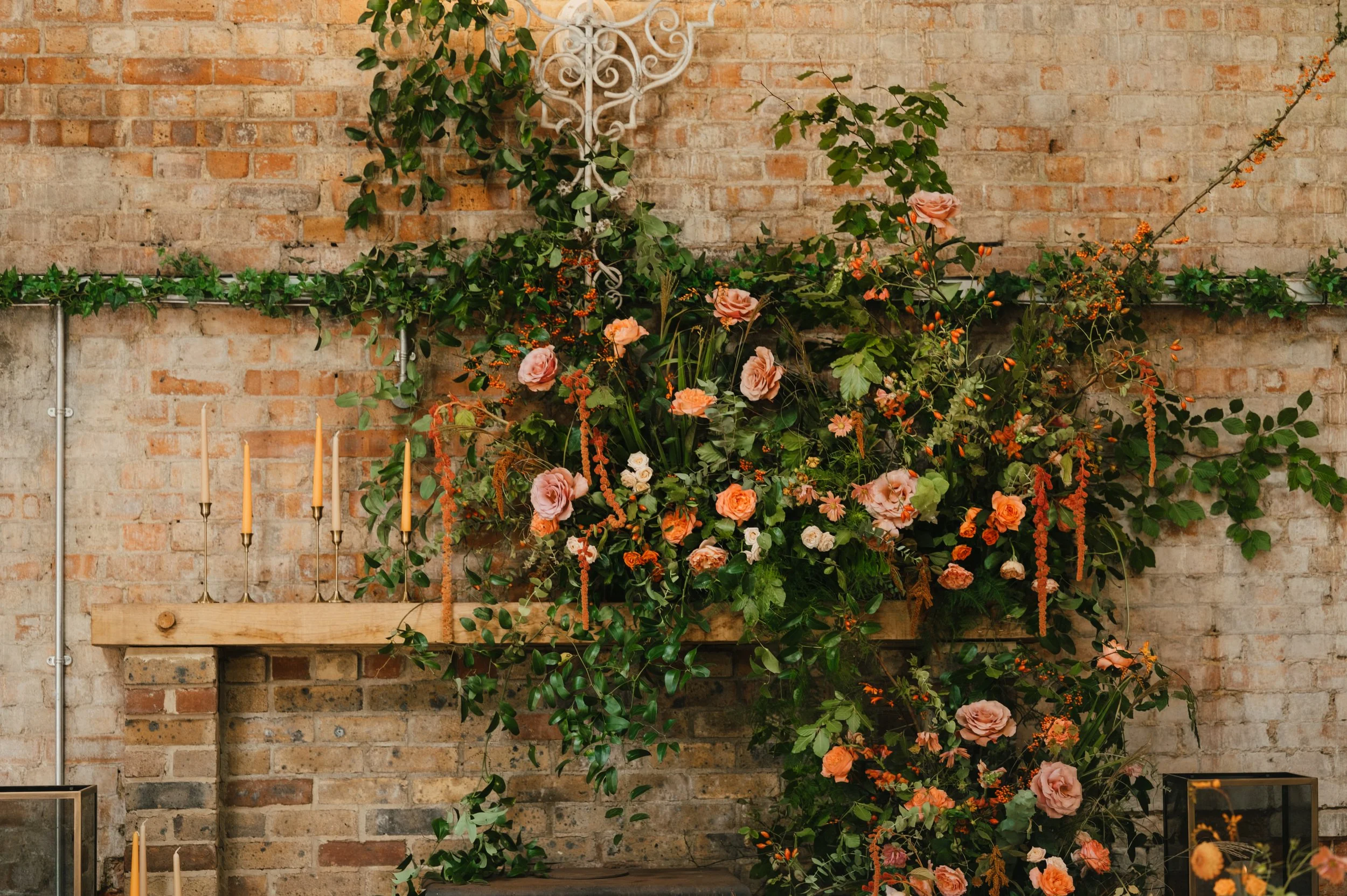 Autumnal Fireplace Design at Botley Hill Barn with gaden roses, amaranthus and candlelight